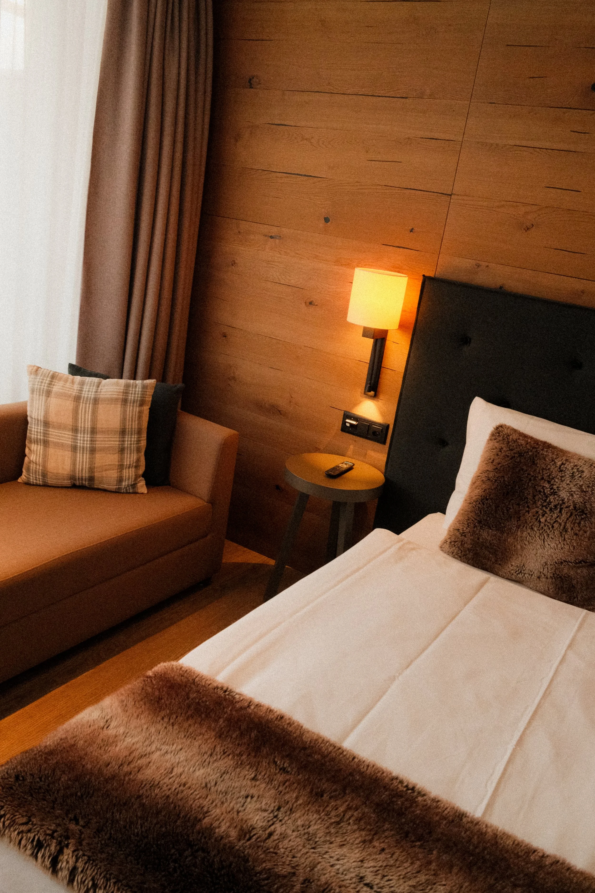switzerland-alpine-hotel-room-tufted-headboard-fur-throw-cozy-hospitality-photography-28.jpg