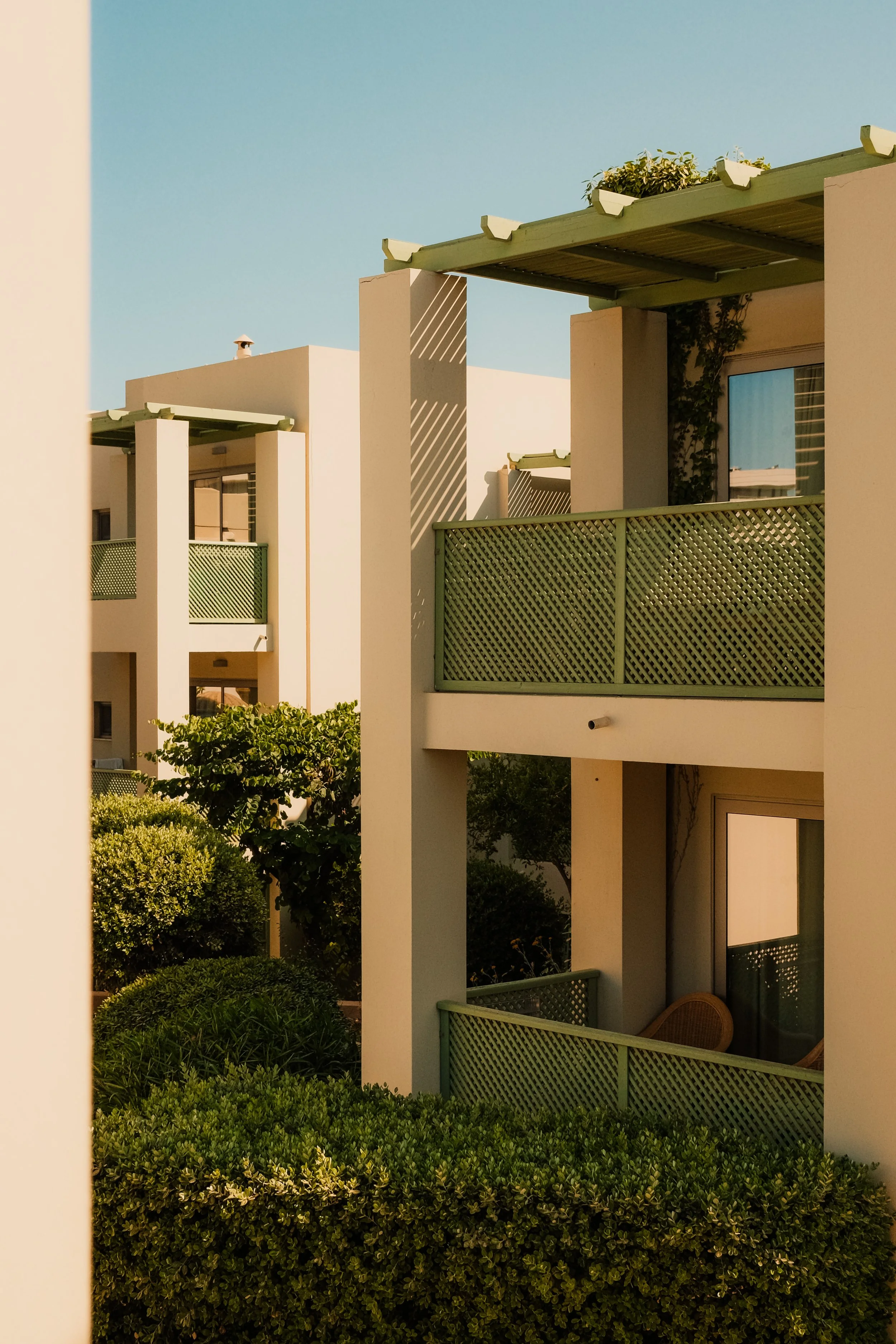 agapi-beach-resort-crete-greece-hotel-bungalow-green-lattice-balcony-garden-golden-hour-hospitality-photography-32.jpg