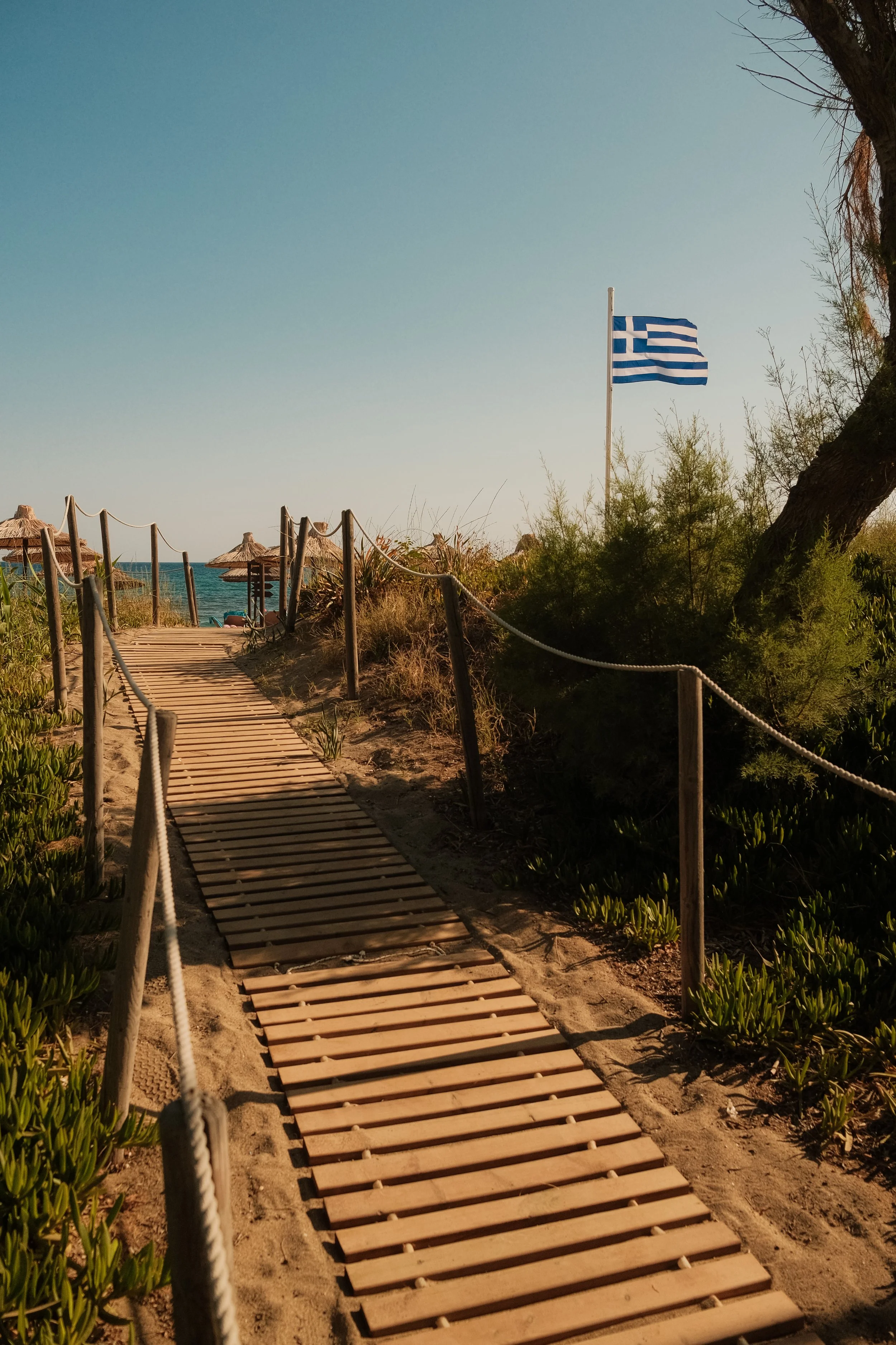 agapi-beach-resort-crete-greece-beach-boardwalk-greek-flag-dunes-sea-travel-photography-31.jpg