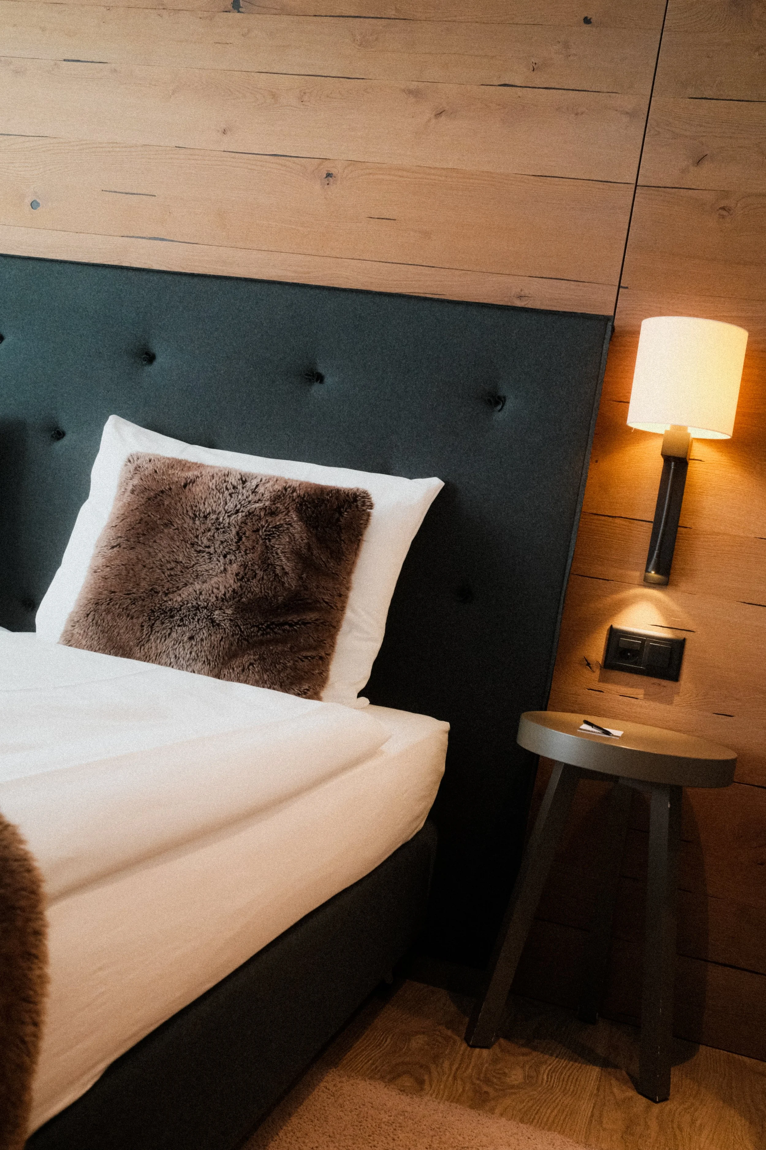 switzerland-alpine-hotel-room-modern-tufted-headboard-fur-pillow-hospitality-photography-26.jpg