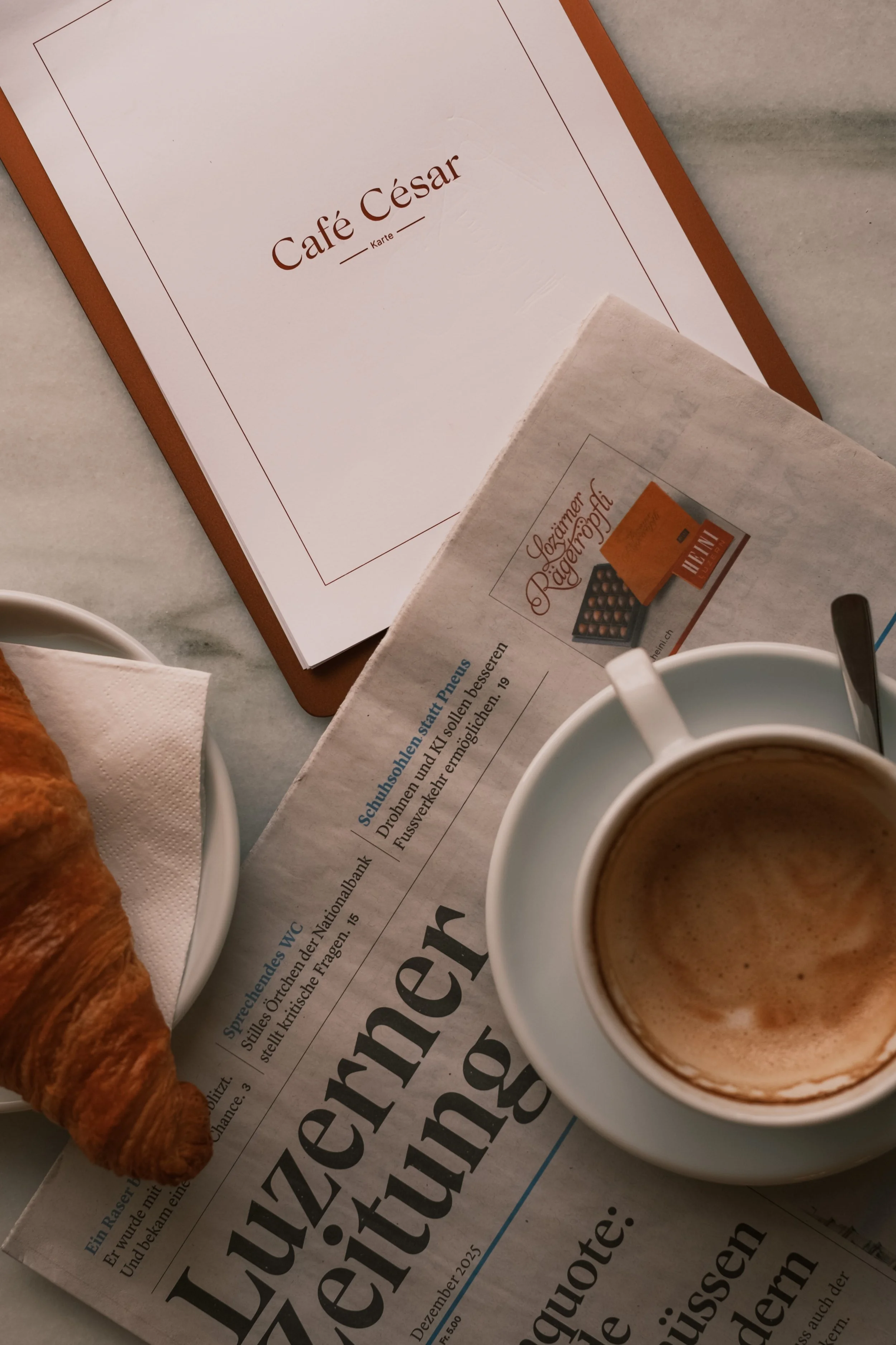 grand-hotel-national-lucerne-switzerland-cafe-cesar-coffee-croissant-newspaper-overhead-hospitality-photography-22.jpg