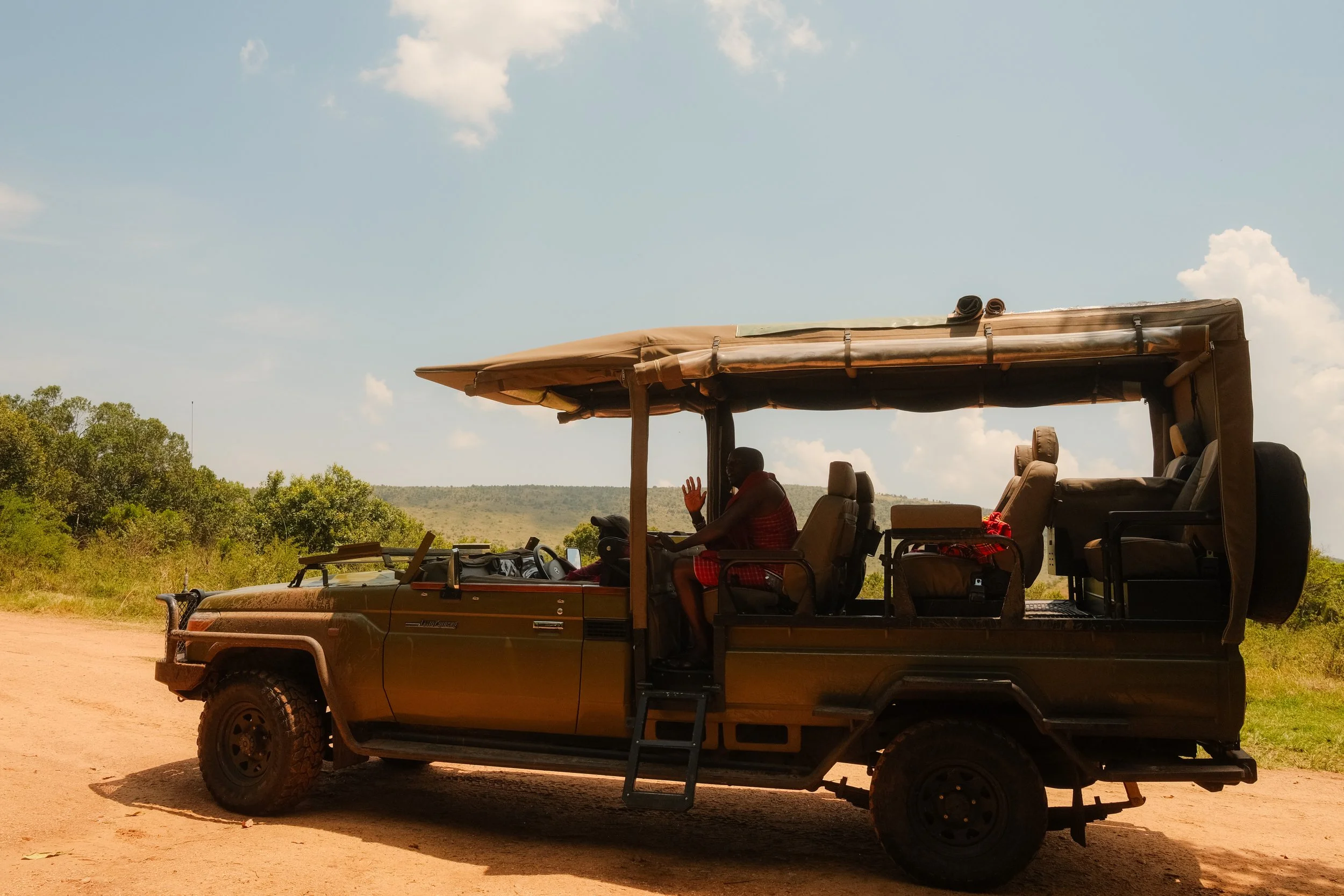 enkewa-safari-camp-masai-mara-kenya-open-top-land-cruiser-game-drive-dirt-road-travel-photography-11.jpg
