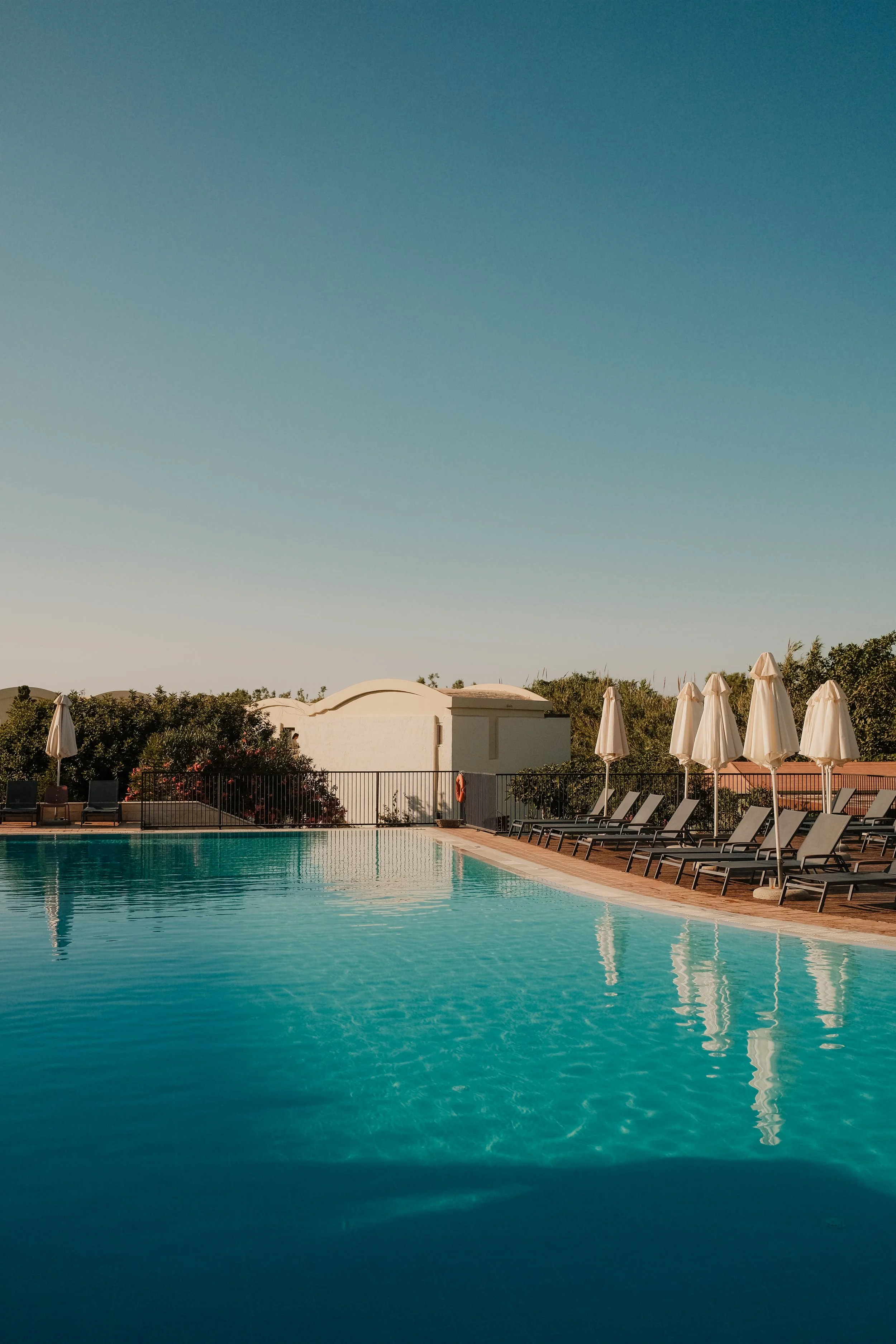agapi-beach-resort-crete-greece-pool-white-umbrellas-lounge-chairs-blue-sky-hospitality-photography-36.jpg