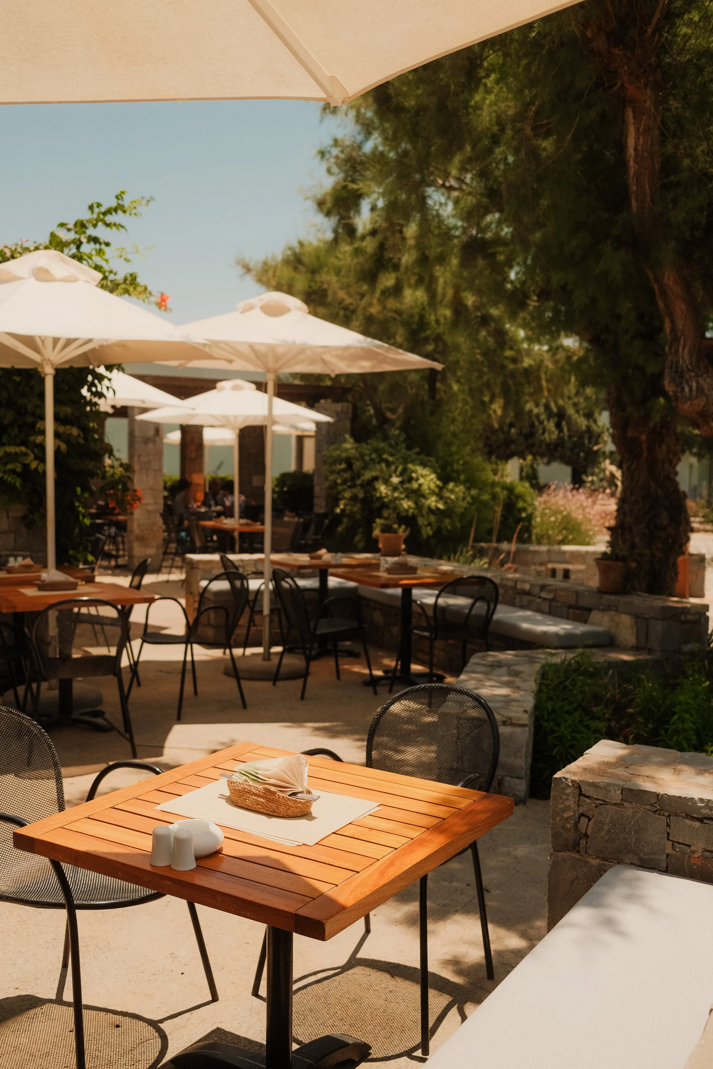 agapi-beach-resort-crete-greece-outdoor-restaurant-terrace-white-umbrellas-dining-hospitality-photography-03.jpg