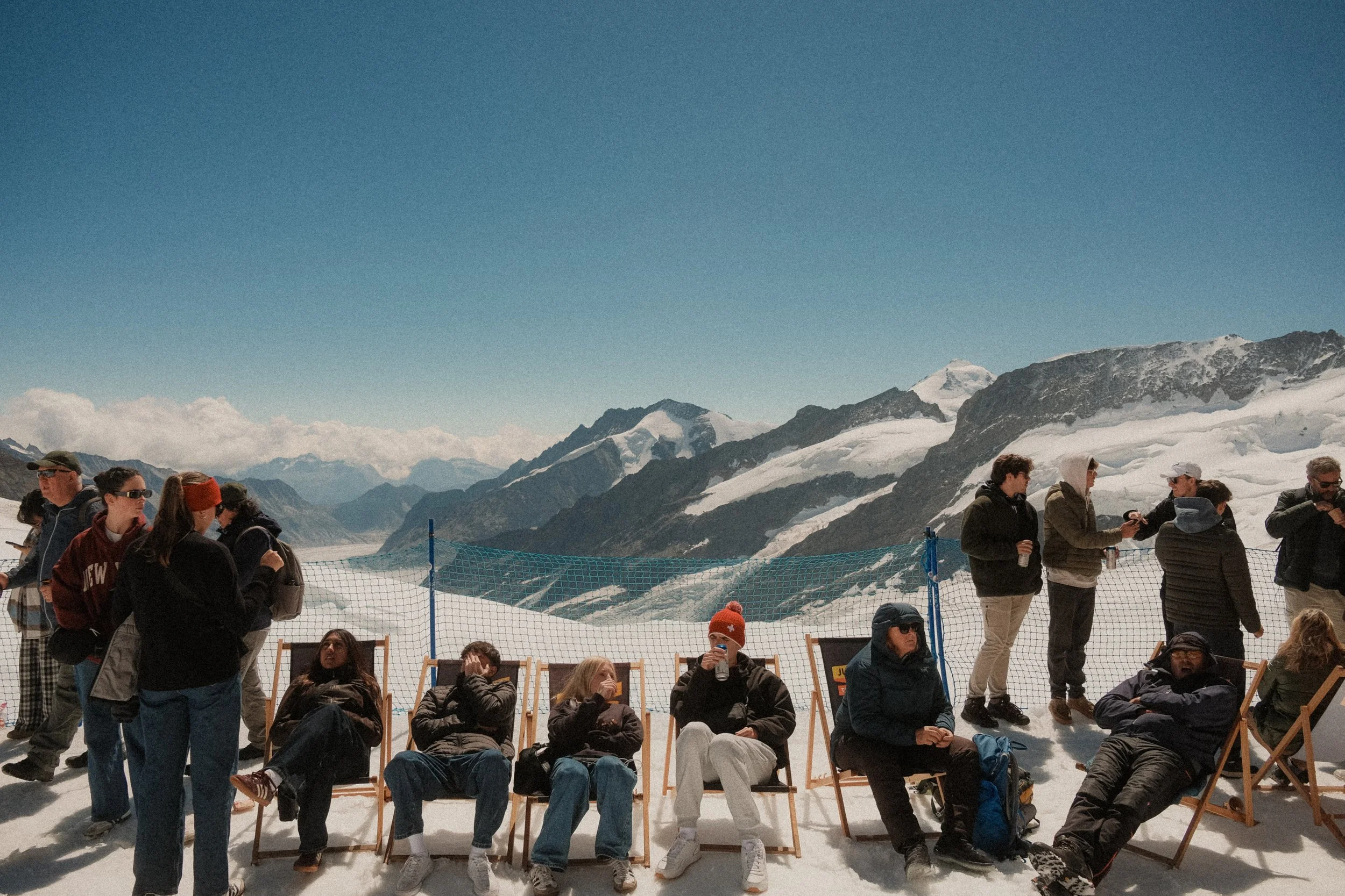 jungfraujoch-switzerland-tourists-deck-chairs-glacier-snow-alpine-travel-photography-12.jpg