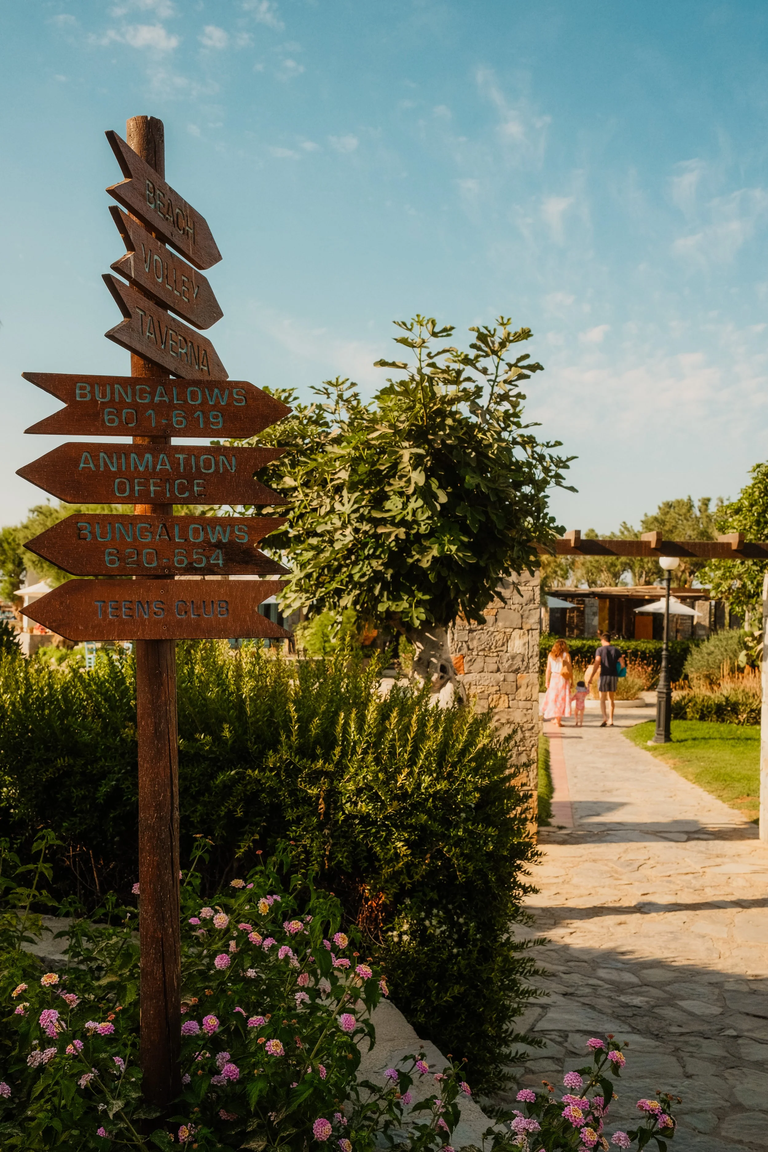 agapi-beach-resort-crete-greece-hotel-garden-directional-signs-bungalows-golden-hour-hospitality-photography-10.jpg