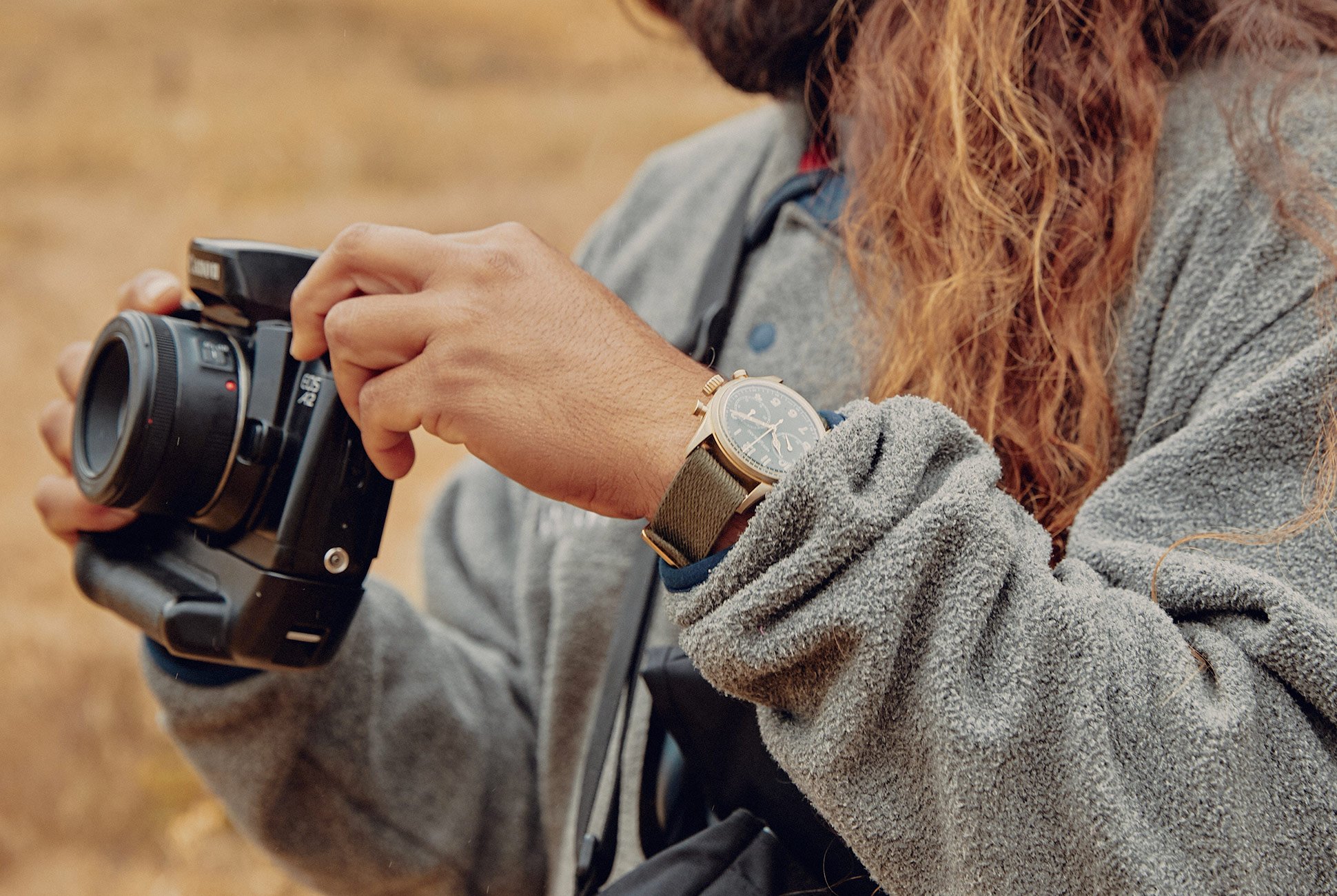 man adjusting his camera