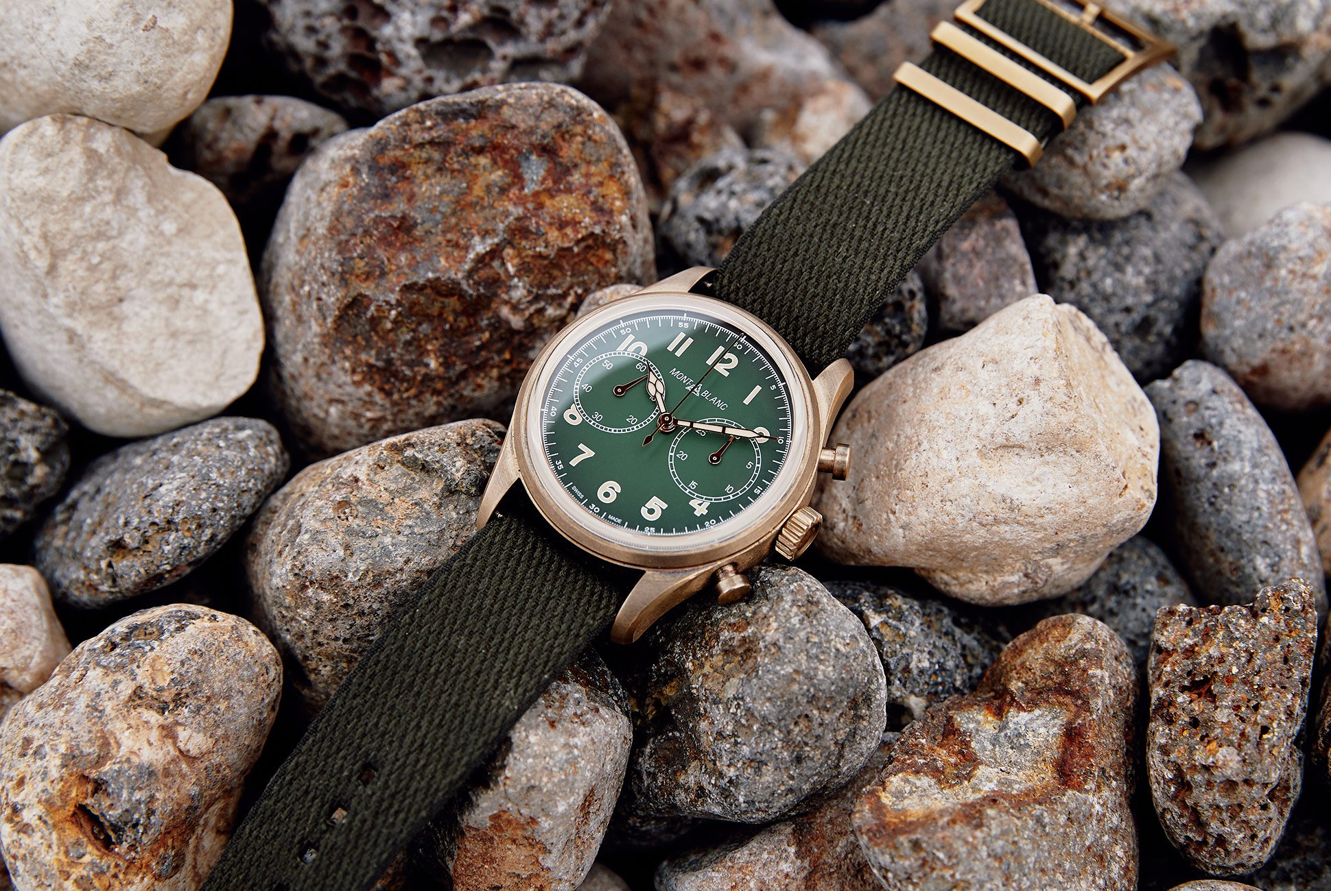 watch laying on top of a rocky beach floor