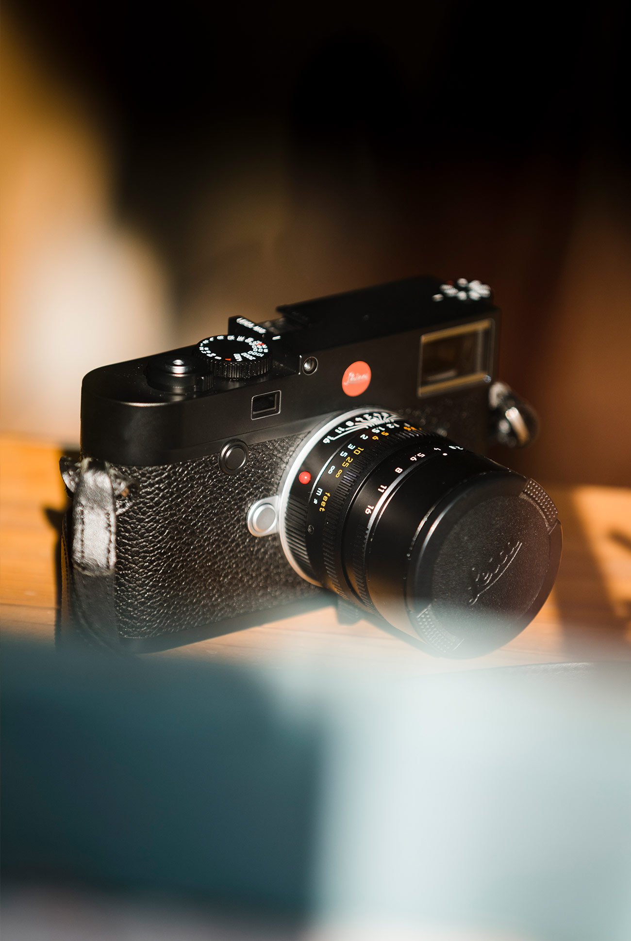 black leica camera on a wooden surface