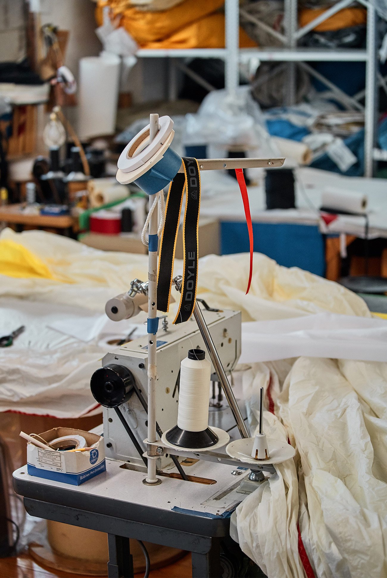 sewing machine set up with a large white piece of fabric