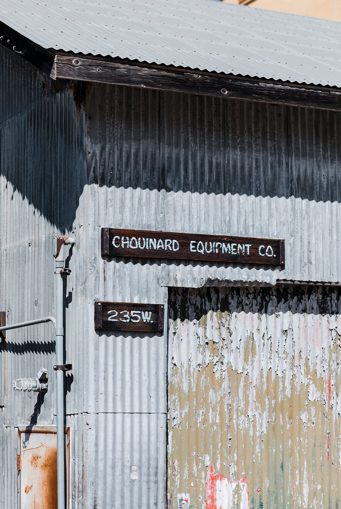 corrugated metal building with a sign reading chouinard equipment co