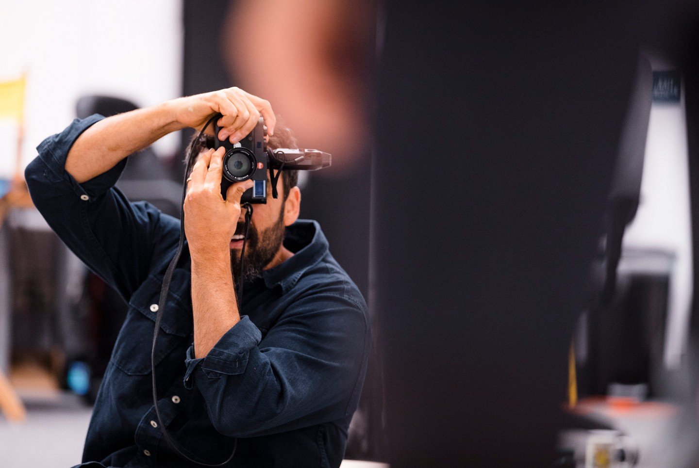 man aiming a camera up to take a photo