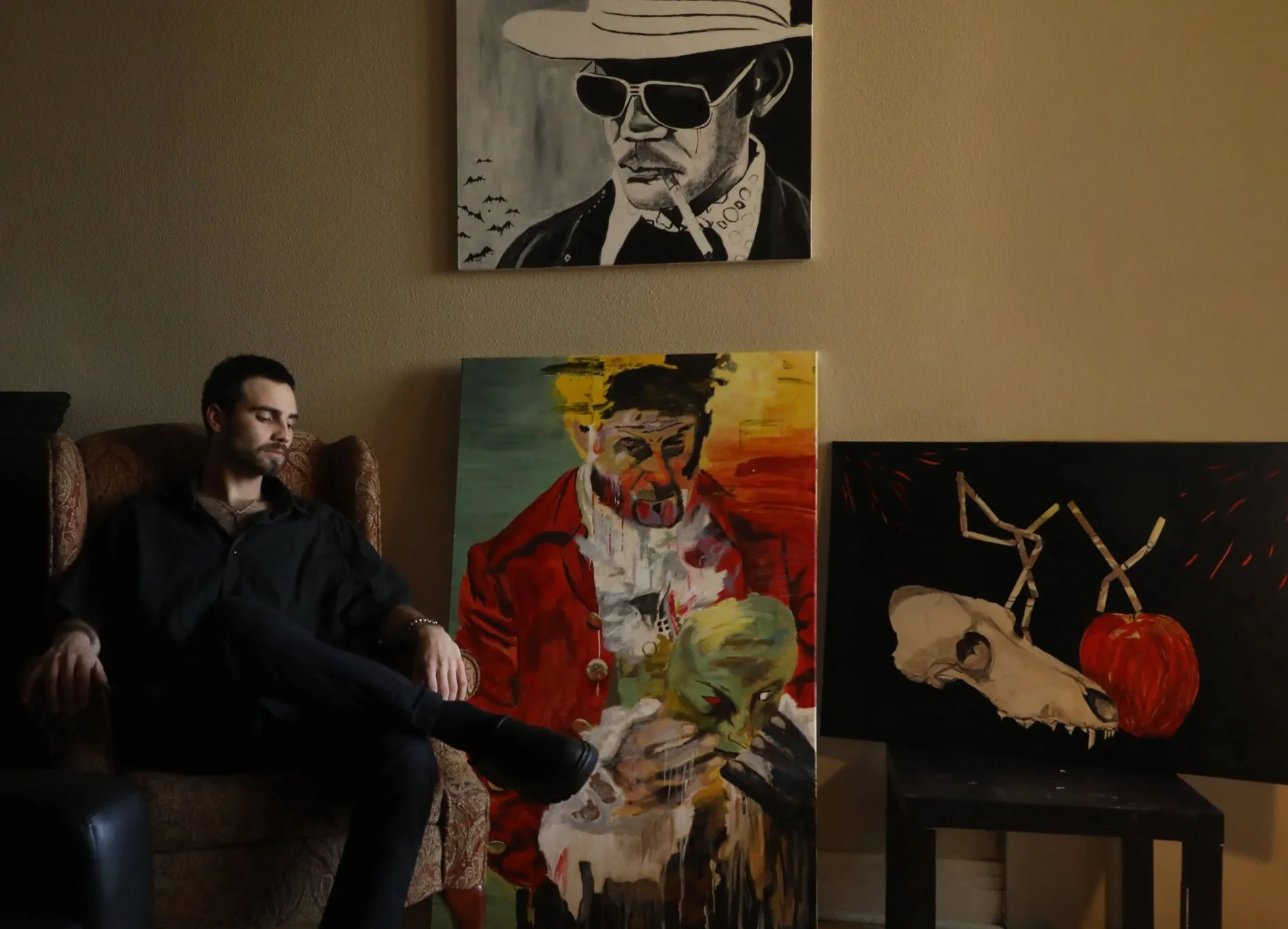 Adam French, 23, Denver, Colorado, looks over a few of his paintings crafted through his college career at Metropolitan State University on November, 29, 2021. 