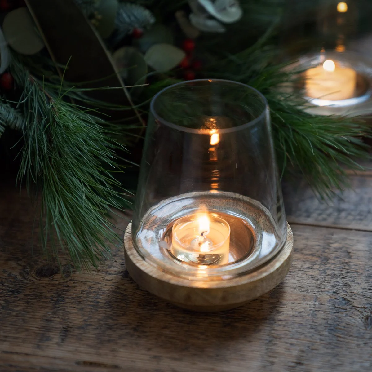 Mango Wood Tea Light Holder. Beautiful glass shaped lantern on a solid wood base.   Height 13 cm  Width 10cm