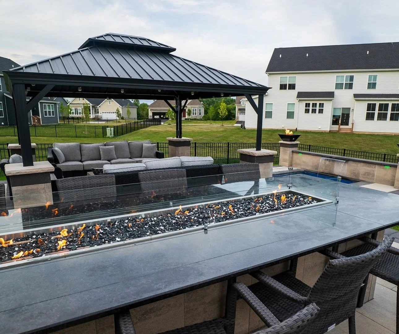 Custom built-in fire pit on stamped concrete patio
