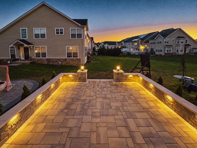 Techo-Bloc Blu 60 paver patio in Chestnut Brown with lit retaining walls