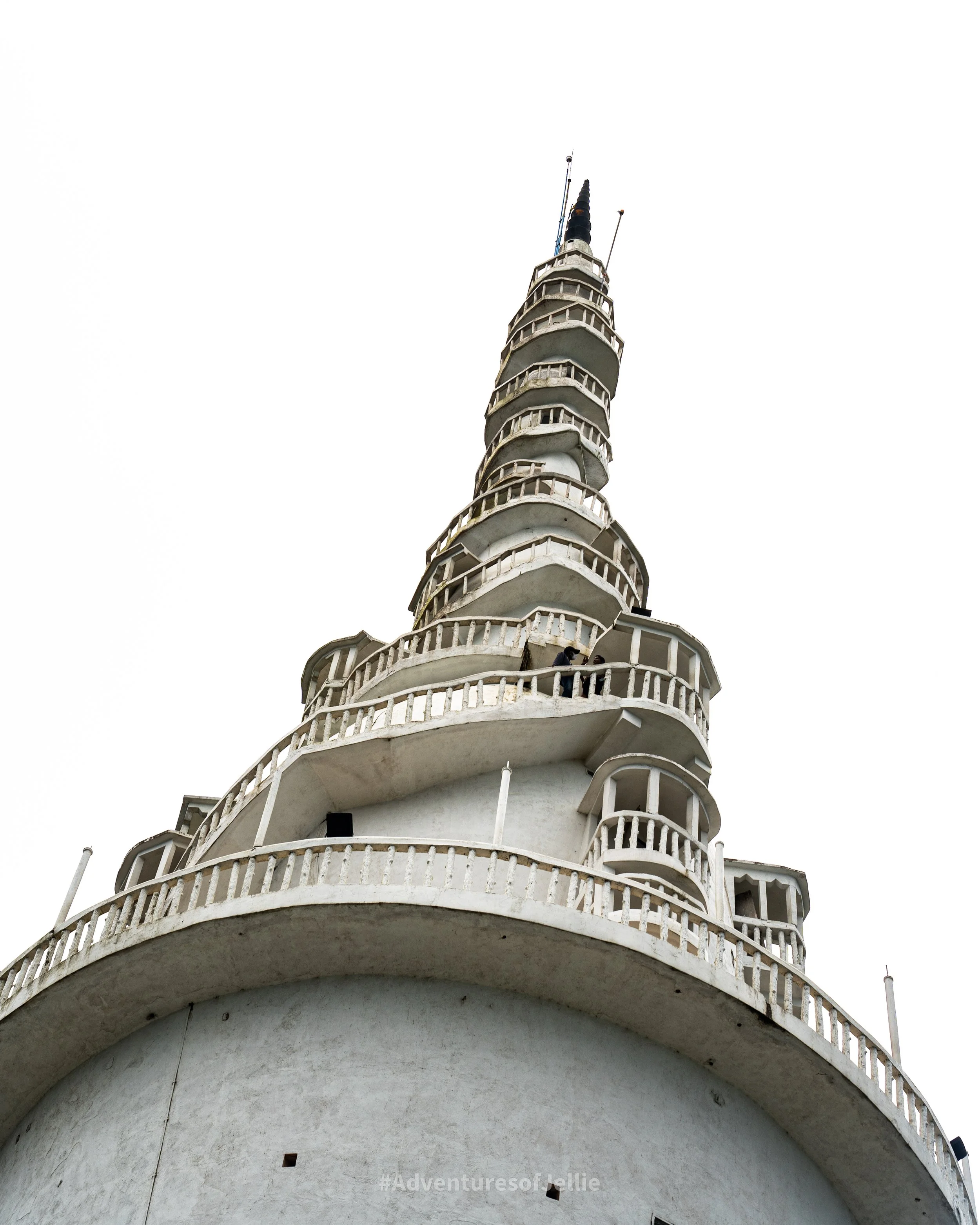 A spiral staircase clings precariously to the outside of the Ambuluwawa Tower in Gampola Sri Lanka.
