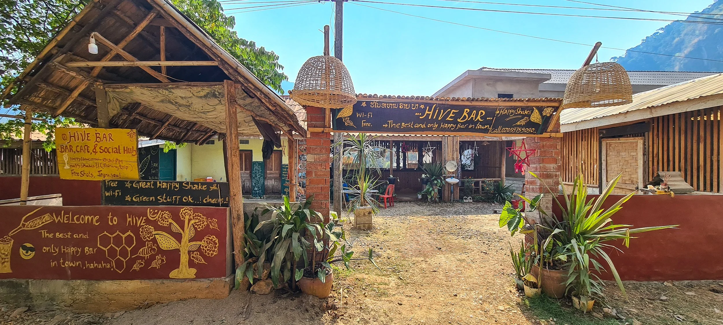 The colour exterior of the Hive Bar in Nong Khiaw in Laos is covered with wooden boards advertising that it is the "best bar in Nong Khiaw".