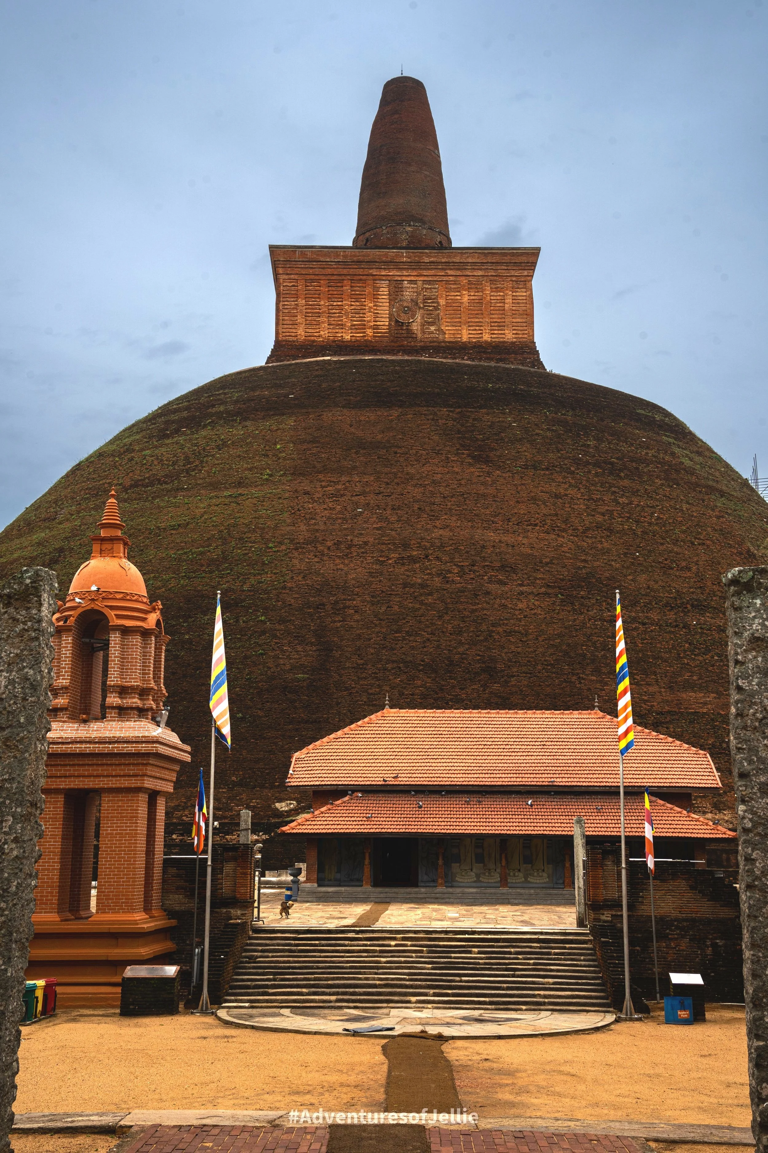 The enormous dome of Abhayagiri Vihara towers above smaller buildings in Anuradhapura ancient city, Sri Lanka