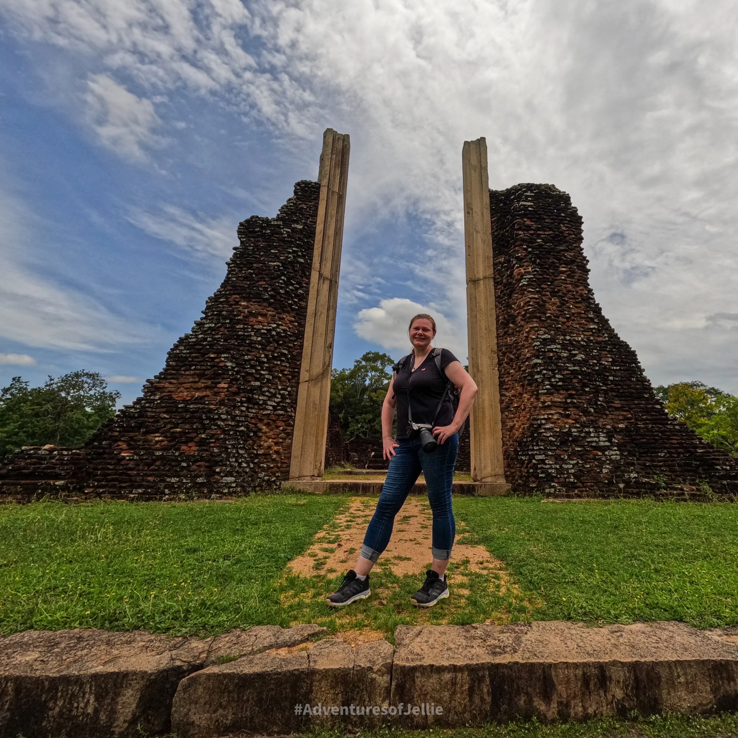 Ellie poses in front of an enormous ruined stone doorway in Anuradhapura's ancient city, Sri Lanka