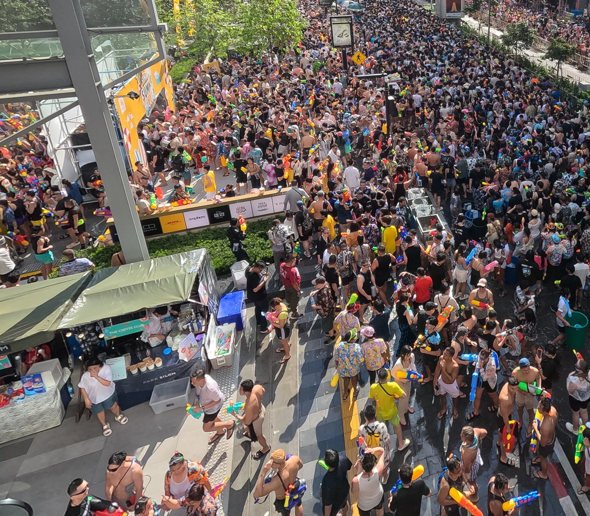 To the side of the Silom Songkran crowds a set of street food stalls is clustered.