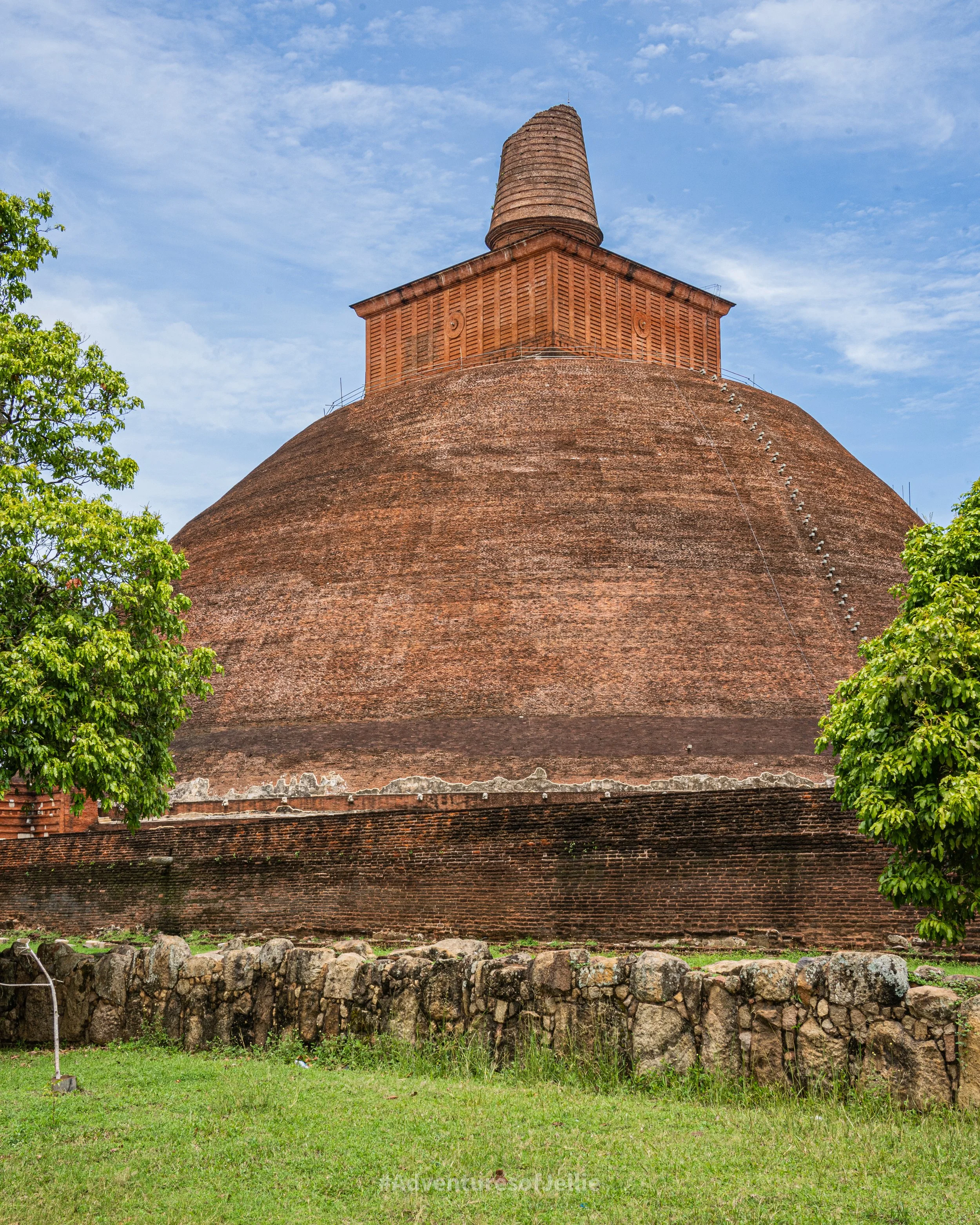 The Jethawanaramaya stupa stands tall amongst green trees in Anuradhapura ancient city, Sri Lanka