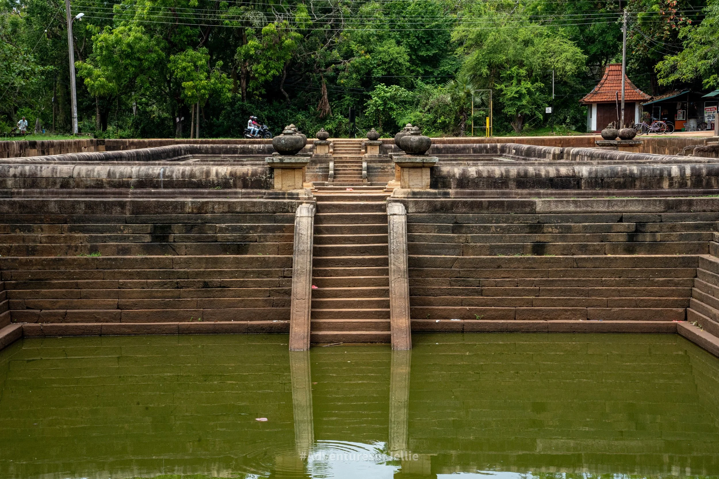 Stone steps lead down into one of the vast Kuttam Pokuna also known as 'Twin Ponds' in Anuradhapura's Ancient City, Sri Lanka.