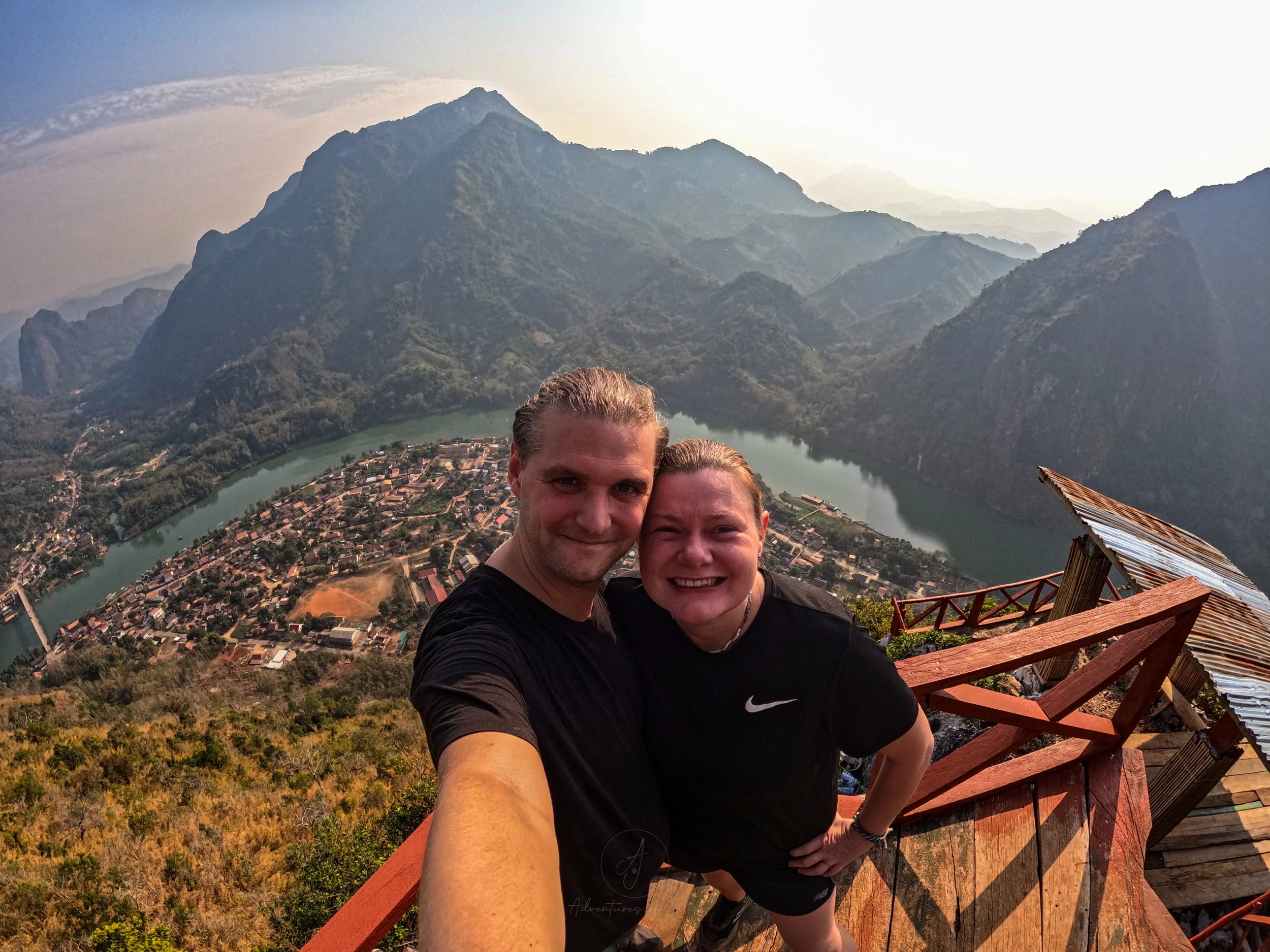Adventures of Jellie pose for a selfie at the top of the Sleeping Lady Viewpoint and hike. Nong Khiaw, the Nam Ou river and mountains stretch away to the horizon.