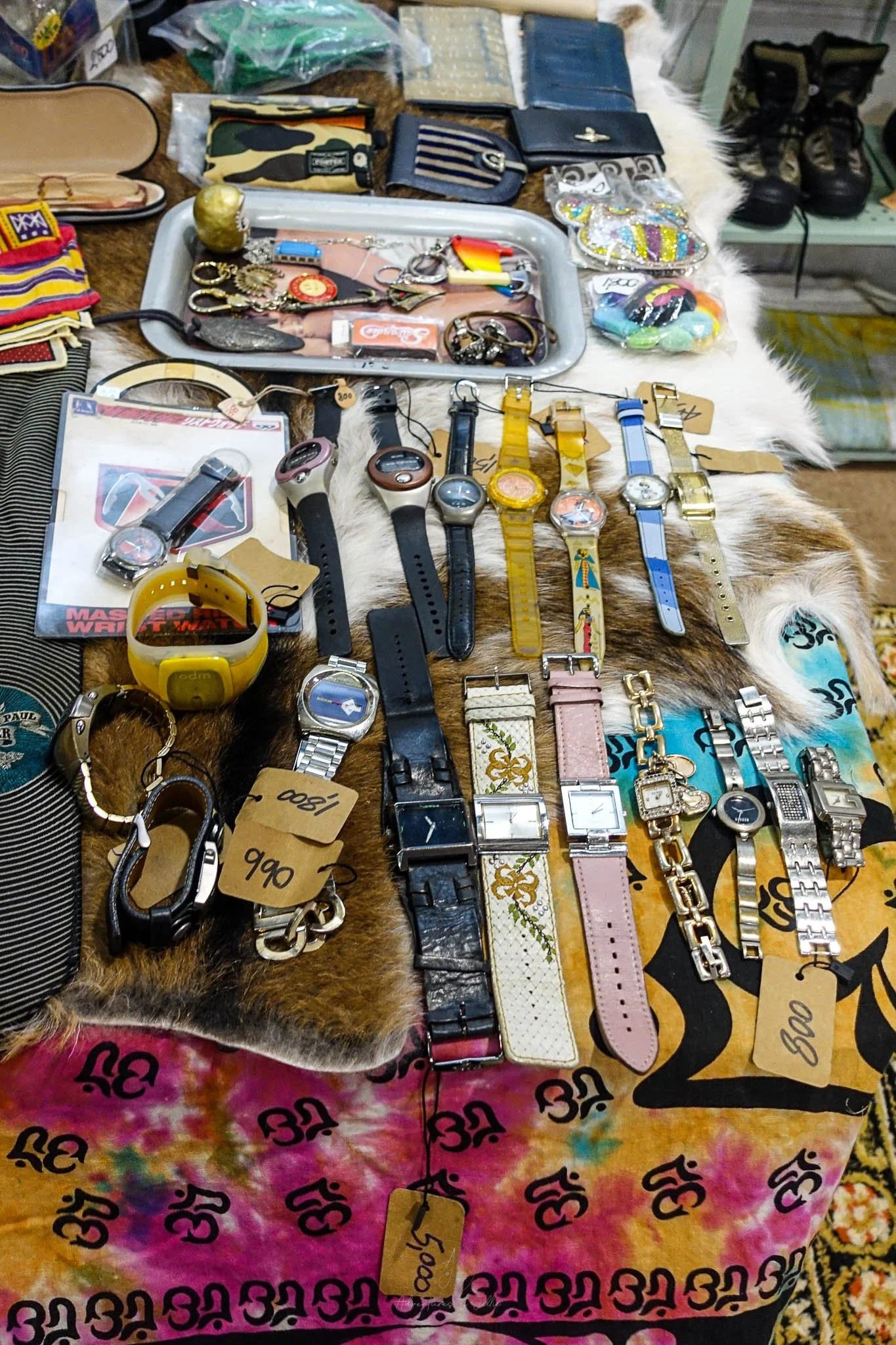 Sitting on top of a market stall table are watches of every kind and style, keyrings, wallets and purses at the Re:Turn Market in Bangkok.