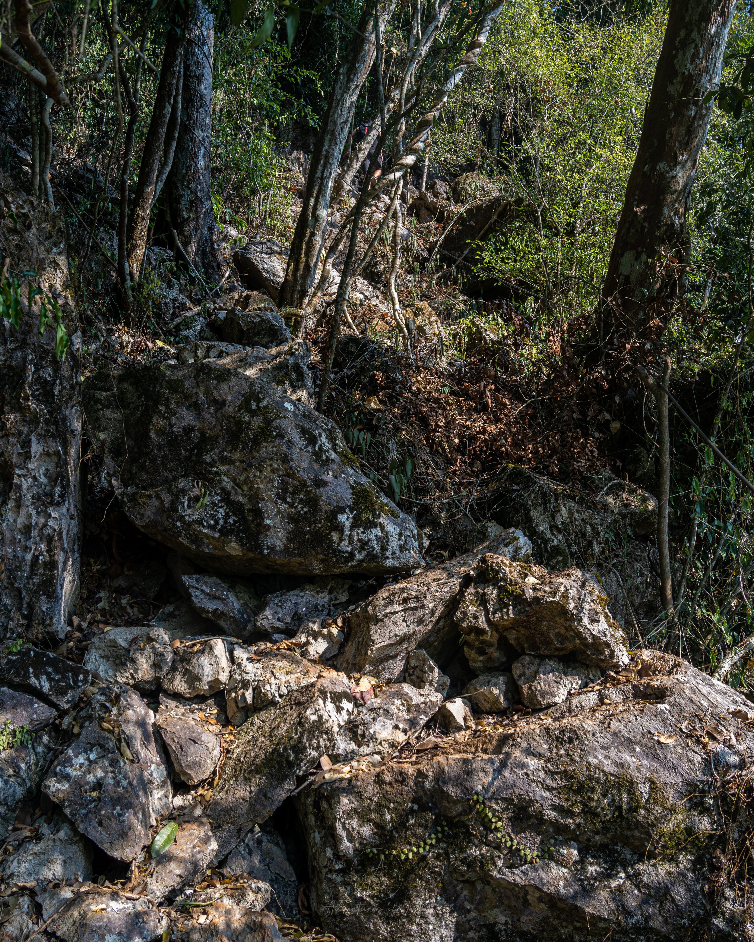 Giant boulders and loose rocks litter the almost vertical trail up to the Sleeping Lady Viewpoint in Nong Khiaw, Laos.
