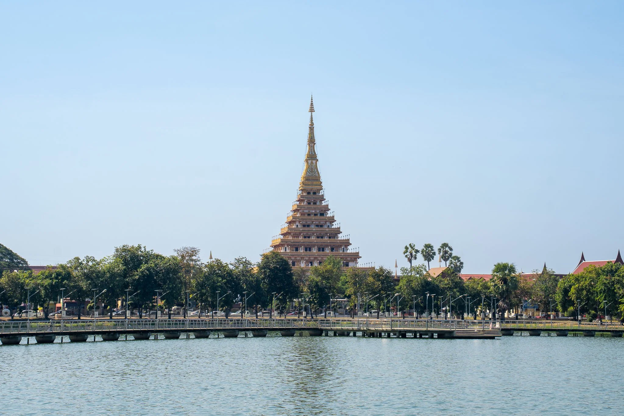 The layered Phra Mahathat Kaen Nakhon (also known as Wat Nong Wang) rises up above the rippling waters of the Kaen Nakhon Lake.