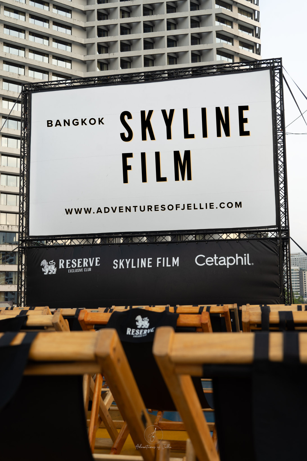 Pinterest Pin for the Adventures of Jellie article - Skyline Film Bangkok. Featuring wooden deck chairs and a big cinema screen.