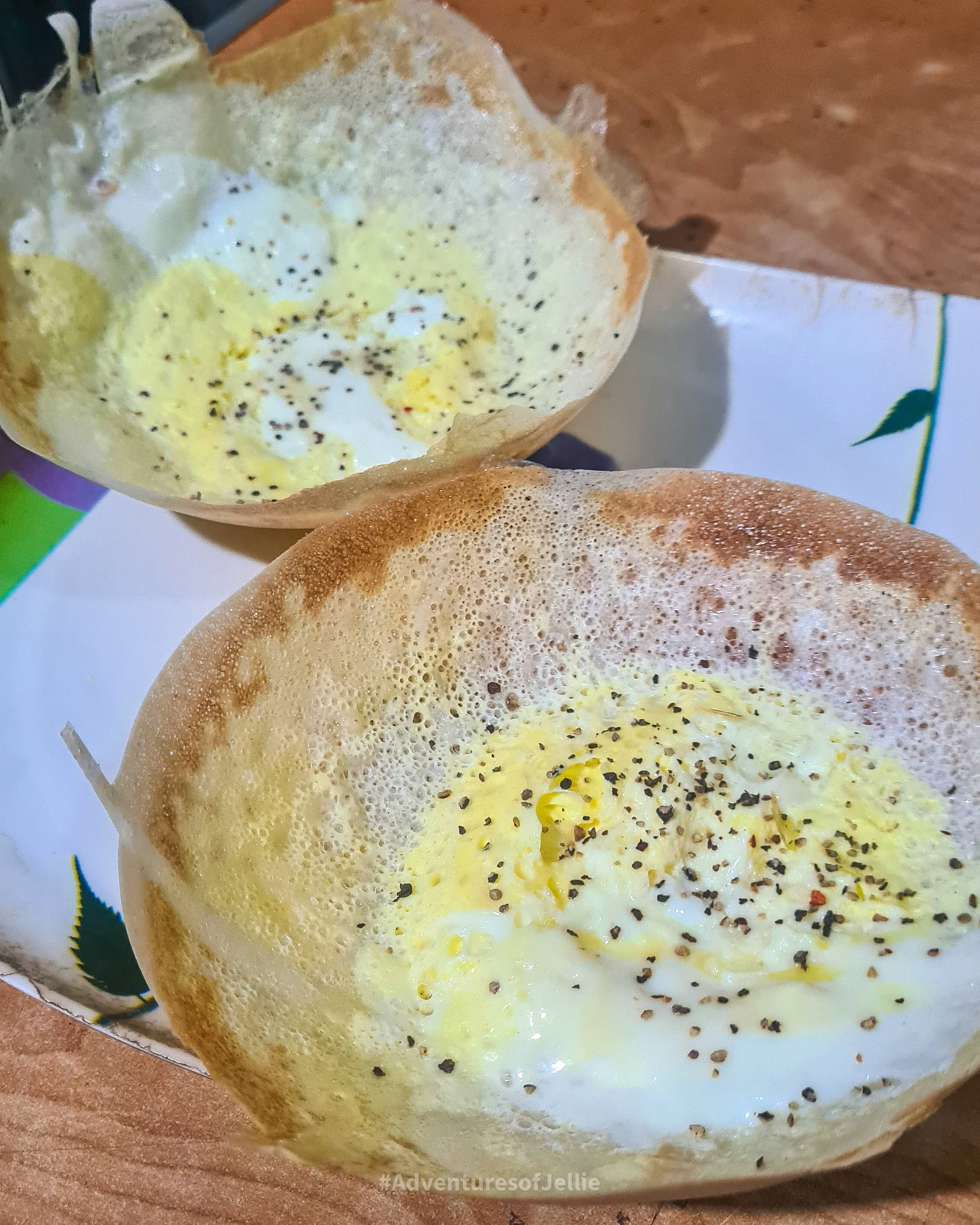 Two egg hoppers sprinkled with black pepper are served in a restaurant in Habarana town, Sri Lanka