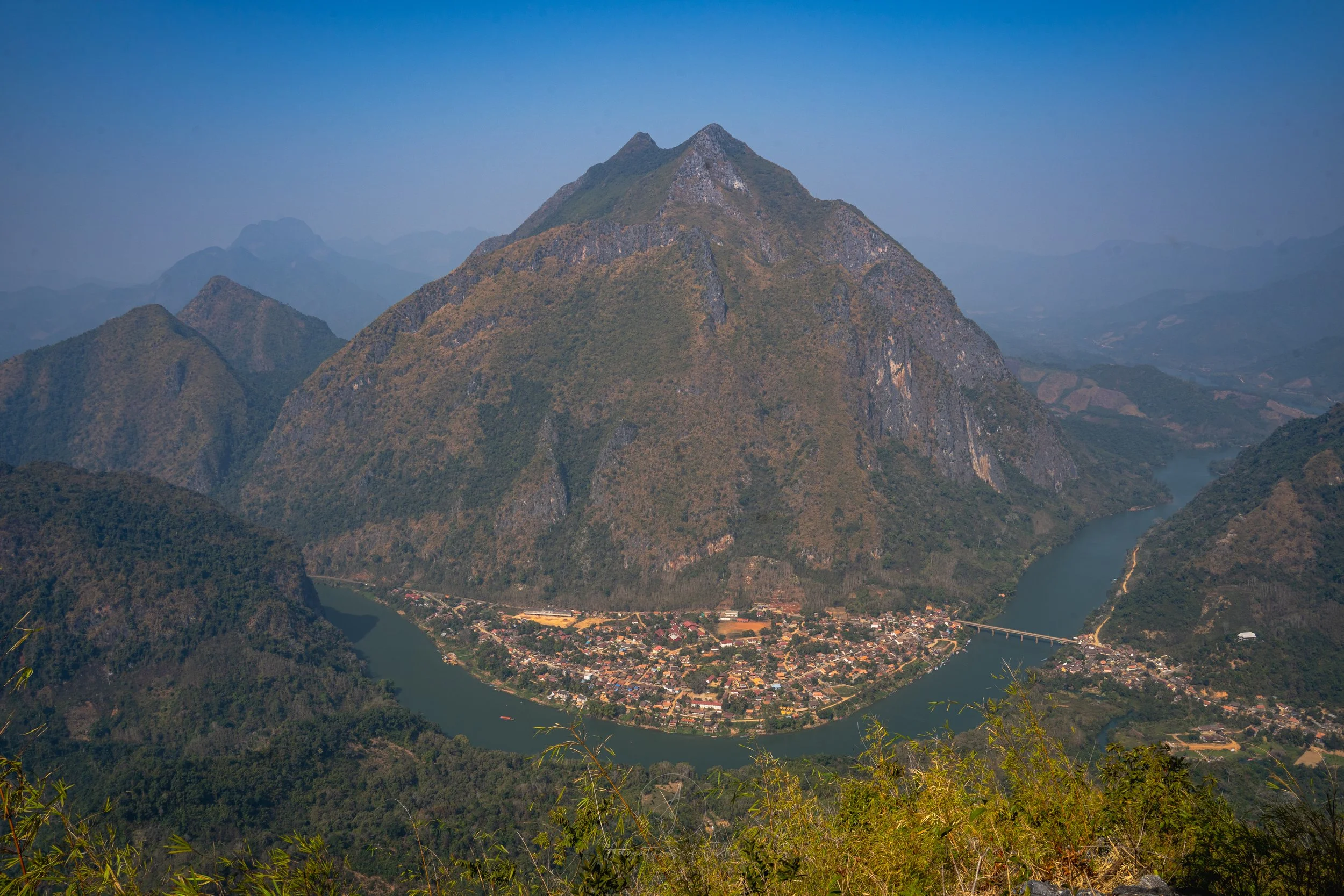 An incredible sweeping vista over Nong Khiaw town, the Nam Ou River and Nong Khiaw's "Everest" Mountain taken from the top of the Pha Kao viewpoint.