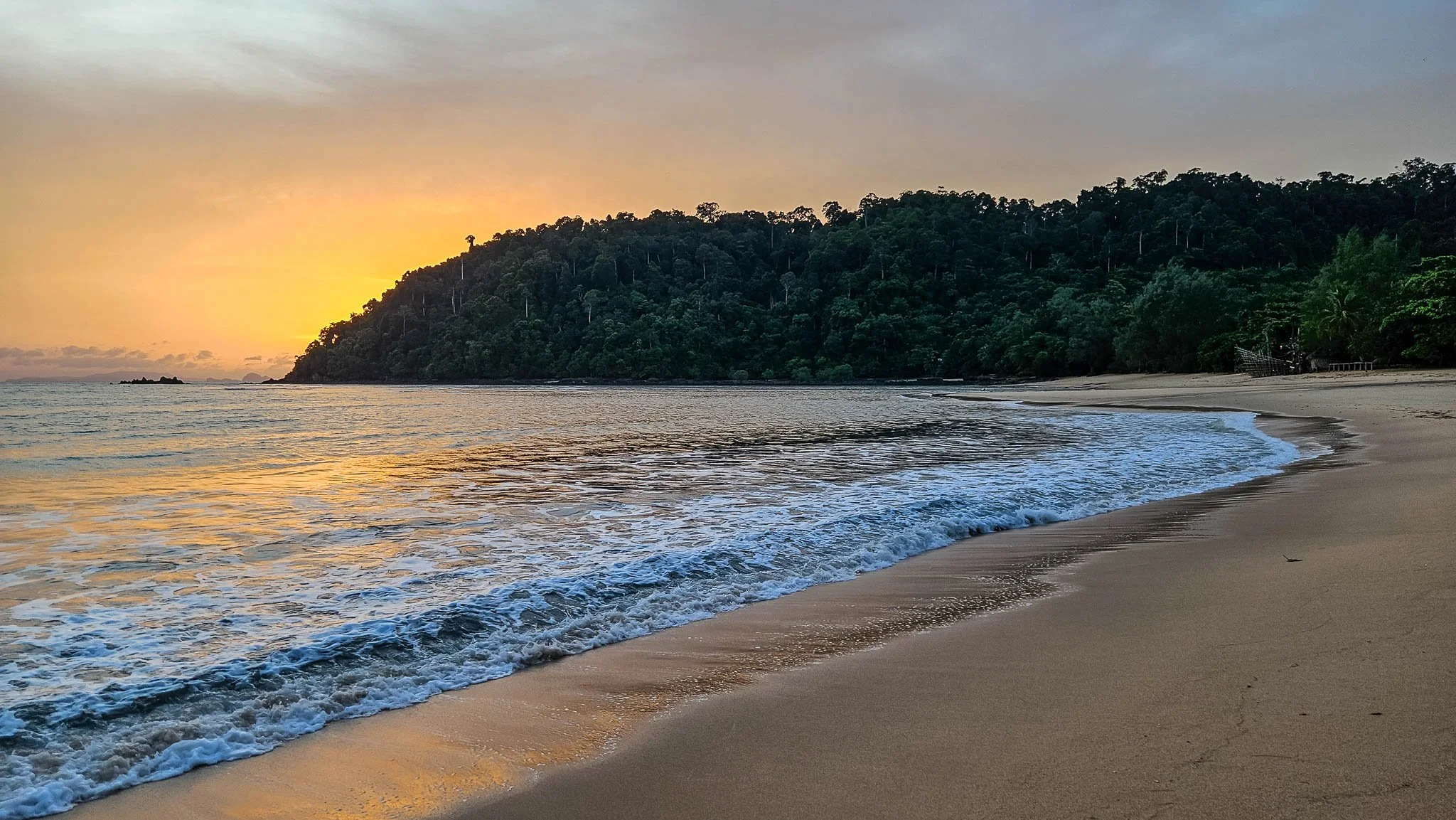 The sunsets over a deserted golden sanded beach on the Thai island of Koh Phayam.