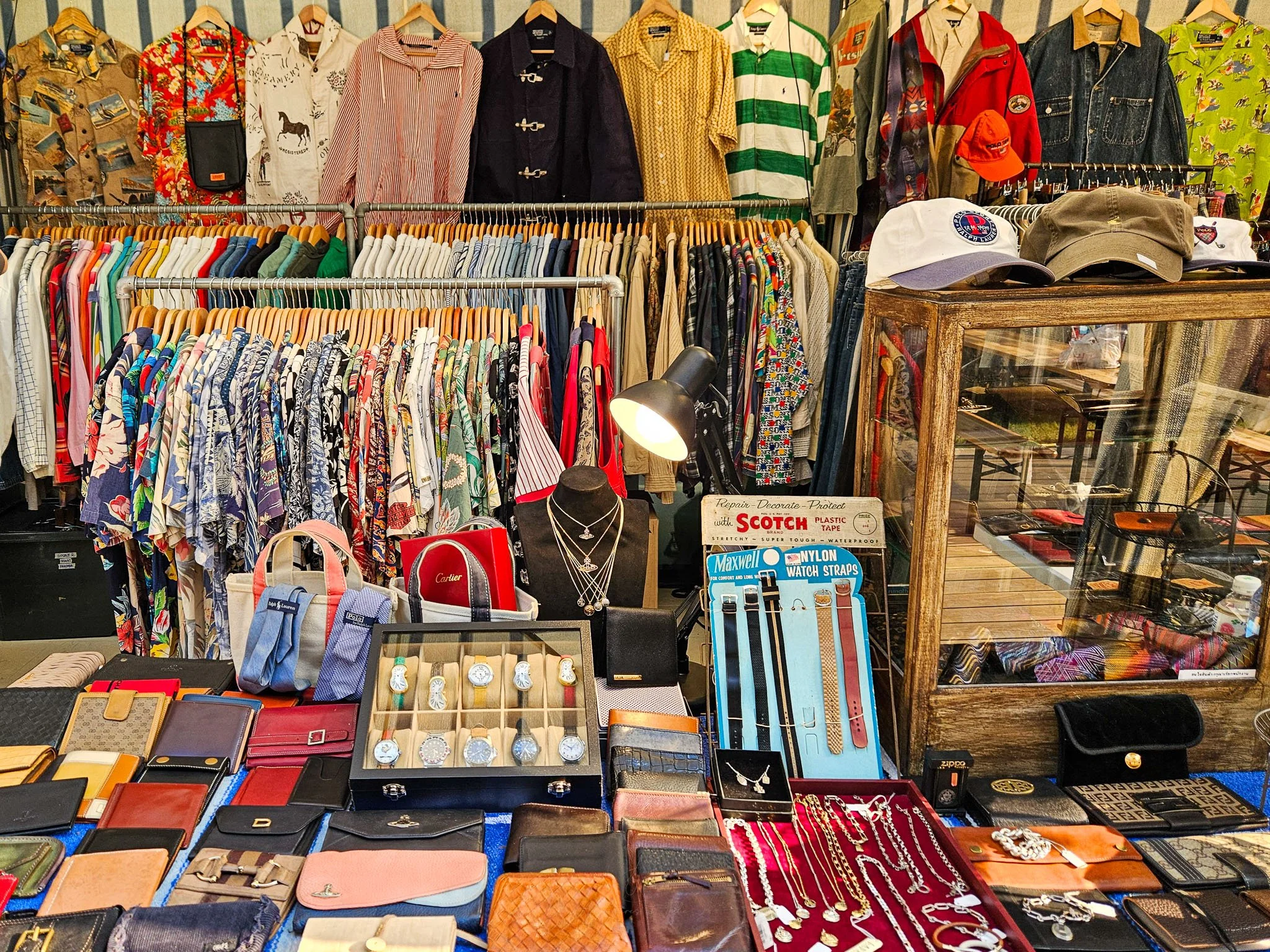 A market stall at the Made By Legacy Flea Market is full of old watches, vintage clothing, caps, wallets and jewellery.