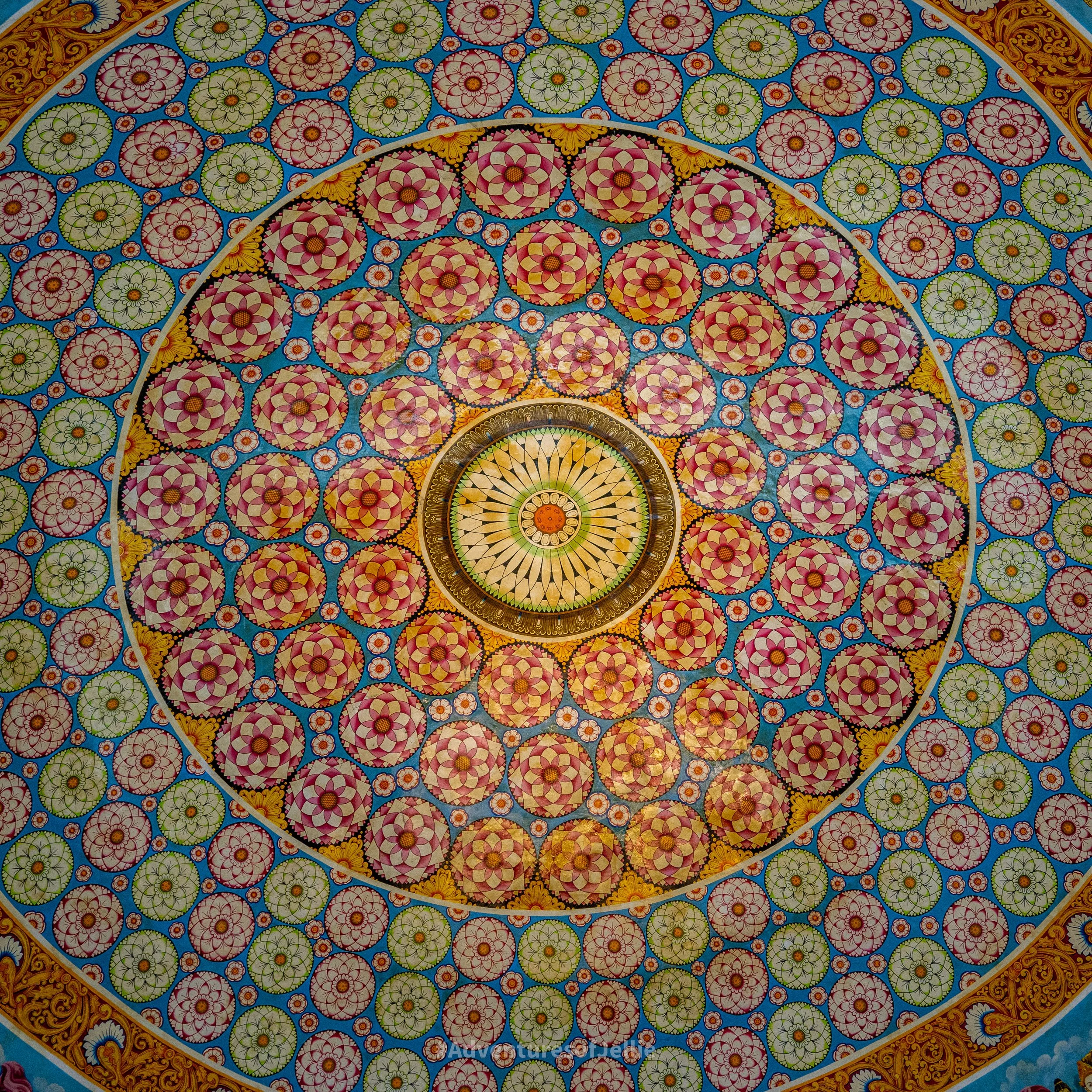 Buddhist mandalas and wheels decorate the colourful interior of the Asgiri Maha Vihara Pirivena.