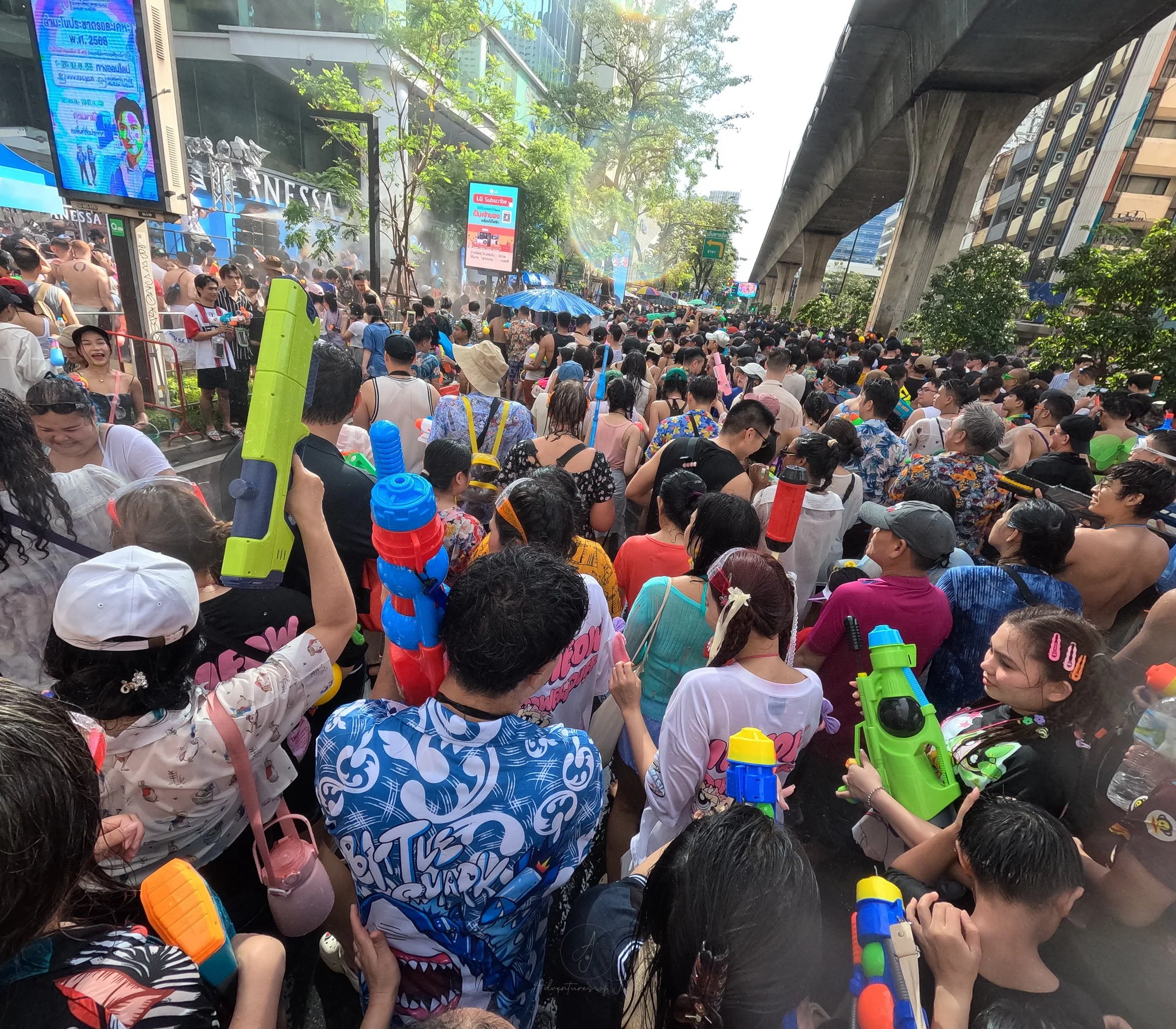 A street full of Songkran revellers with waterguns of all shapes and sizes
