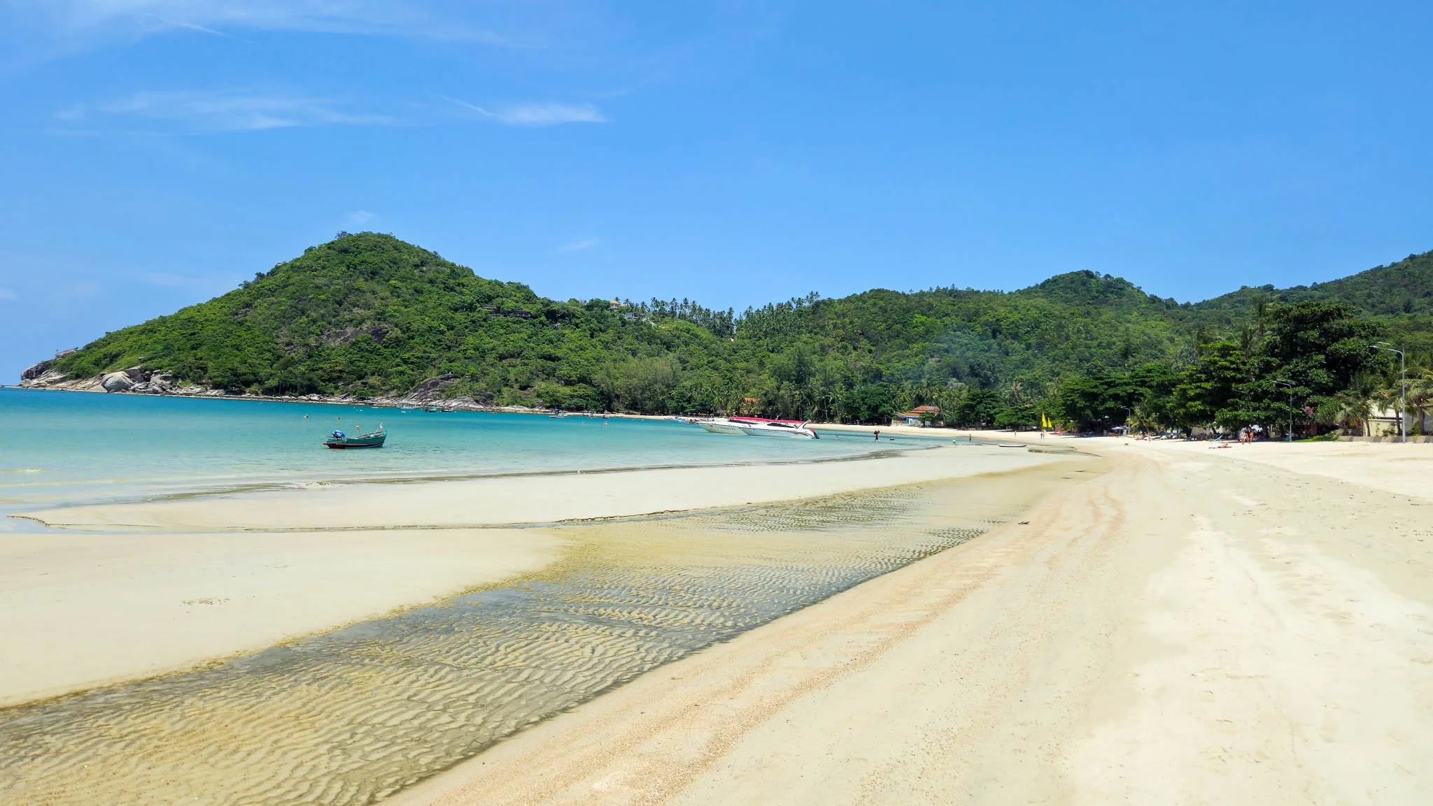 Bright white sand and vibrant blue sea line the coast at Thong Nai Pan Yai Beach on Koh Phangan.
