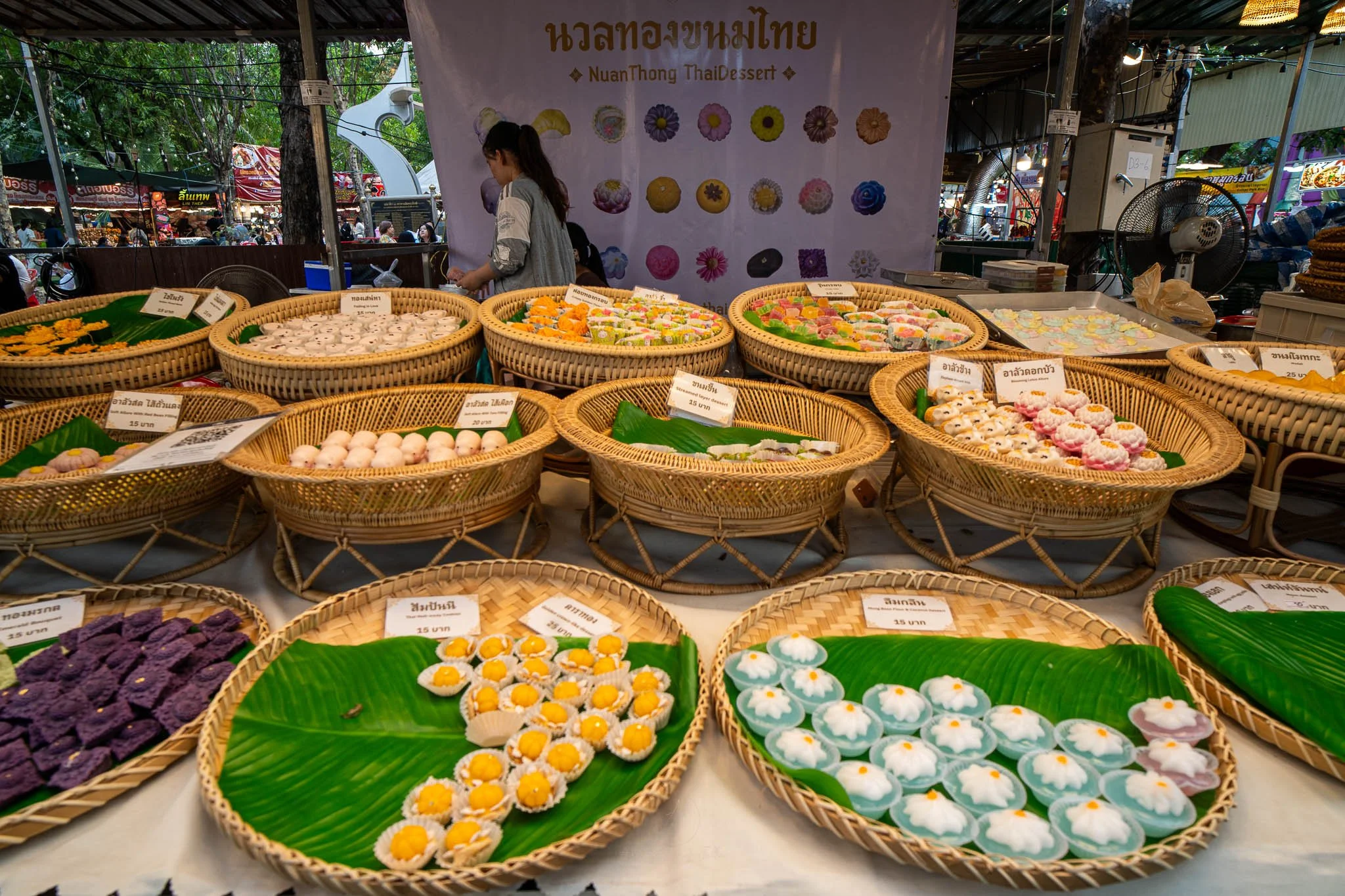 Round wicker baskets are filled with colourful traditional Thai desserts and puddings at the Kaset Fair in Bangkok.