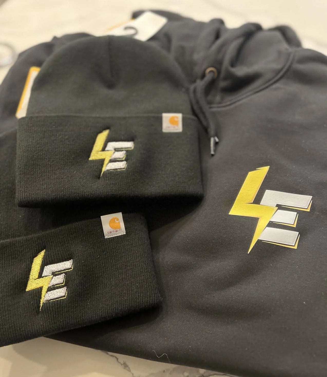 Embroidered Carhartt Banies and DTF Hoodies Printed Front & Back for Lopes Electric out of New Bedford, MA.