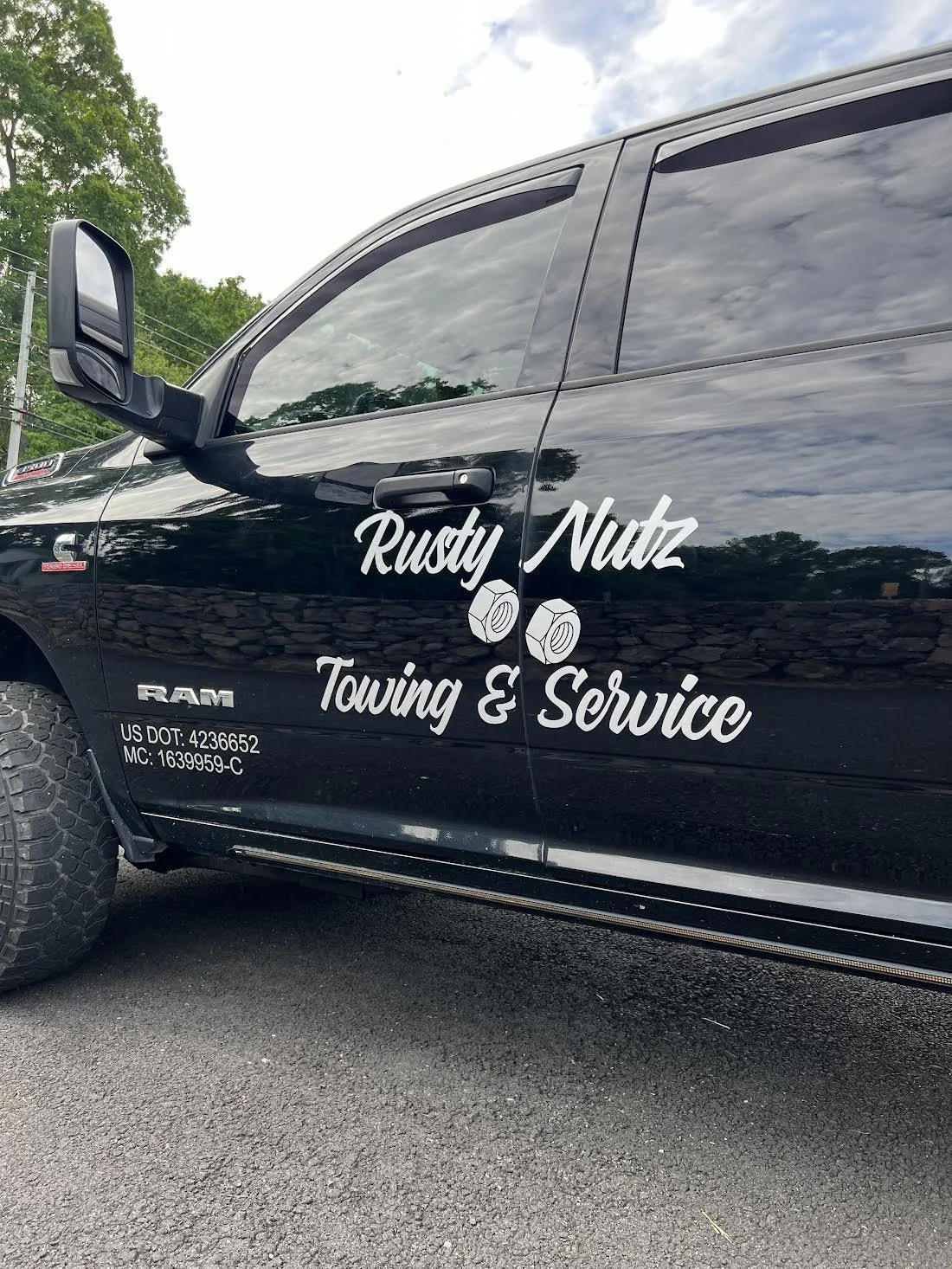 Silver Metallic Premium Cast Vinyl spanning across both doors for Rusty Nutz Towing Service!