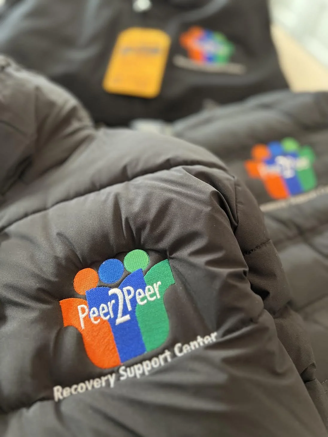Clean looking Embroidery work for Peer2Peer Recovery Center on Some Heavy Winter Jackets.