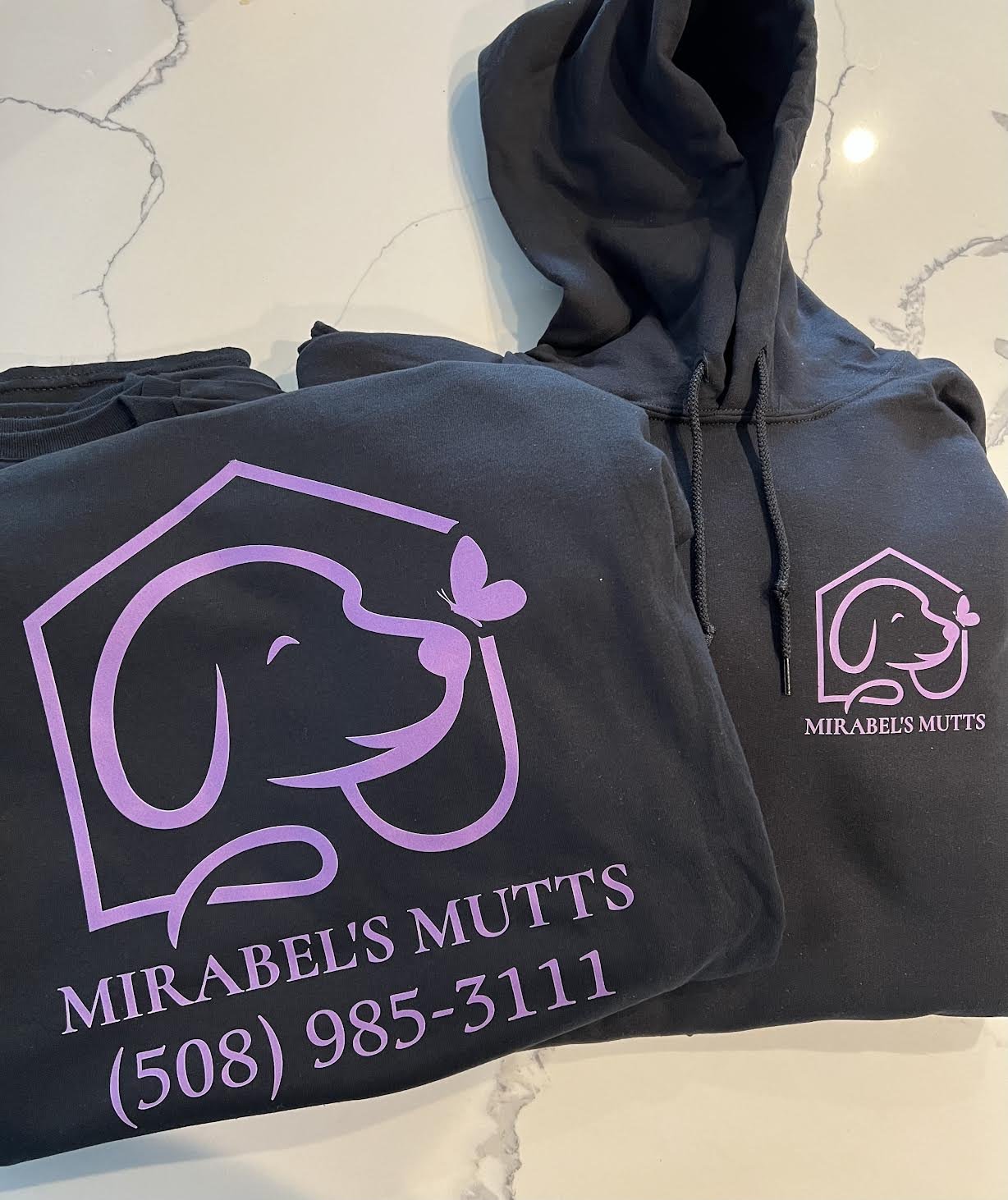 Beautiful Violet pop! on these Black hoodies.  DTF Printed for Mirabel's Mutts!