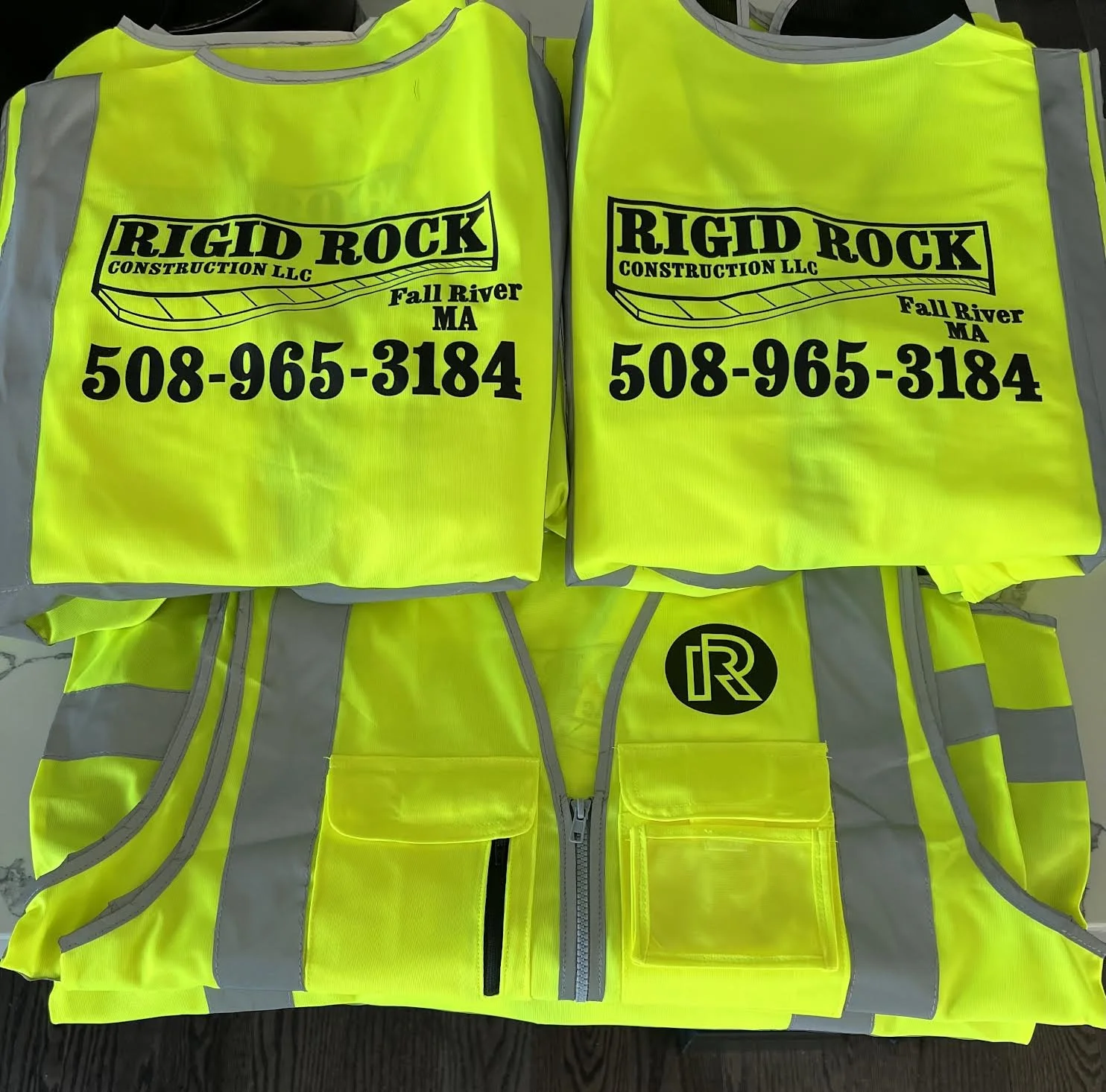 Sleeveless Safety Vests printed front and back for Rigid Rock Construction!