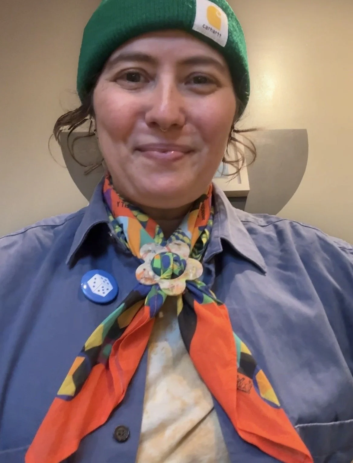 a smiling person wearing bandana slide on the never board bandana board game