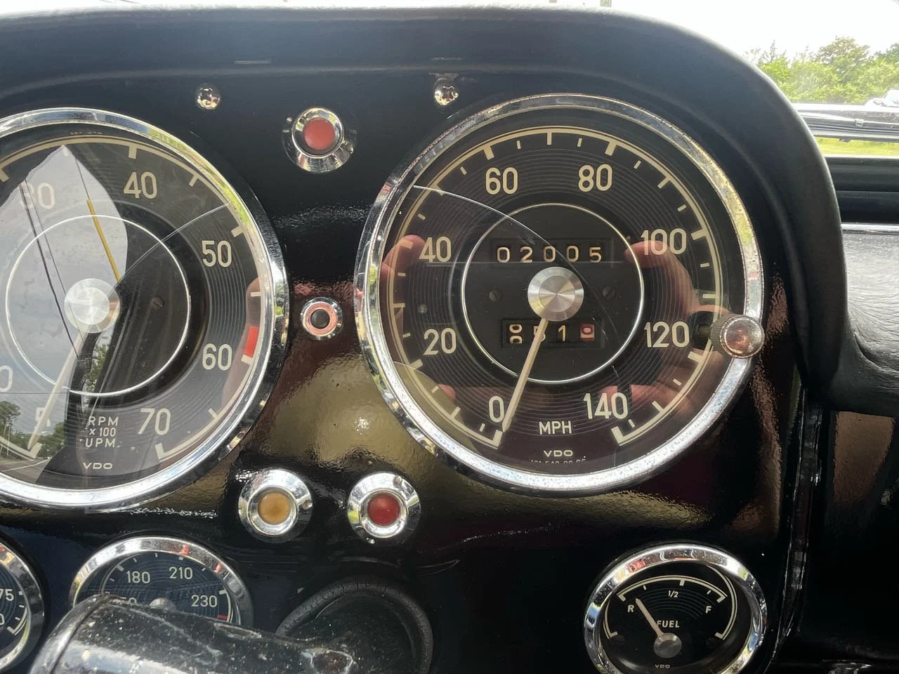 Close-up of a vintage car dashboard with speedometer, tachometer, and fuel gauge.