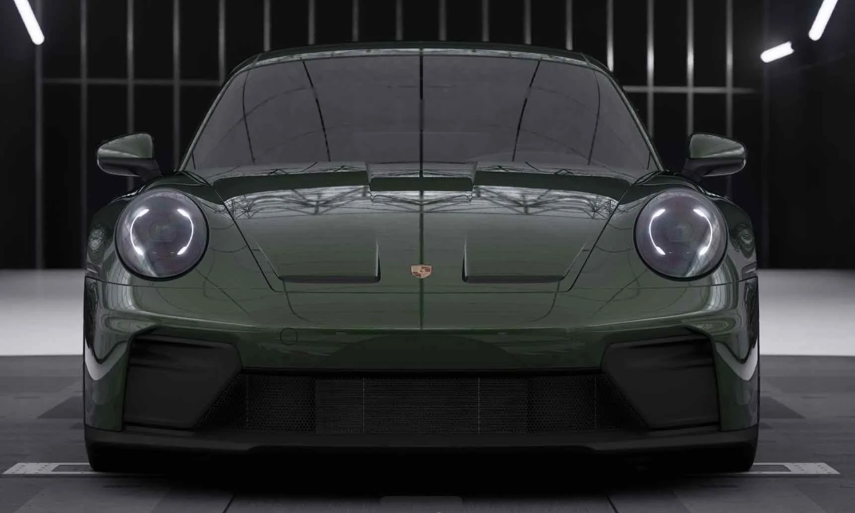 Front view of a sleek green Porsche sports car inside a modern showroom with black walls and bright lights.