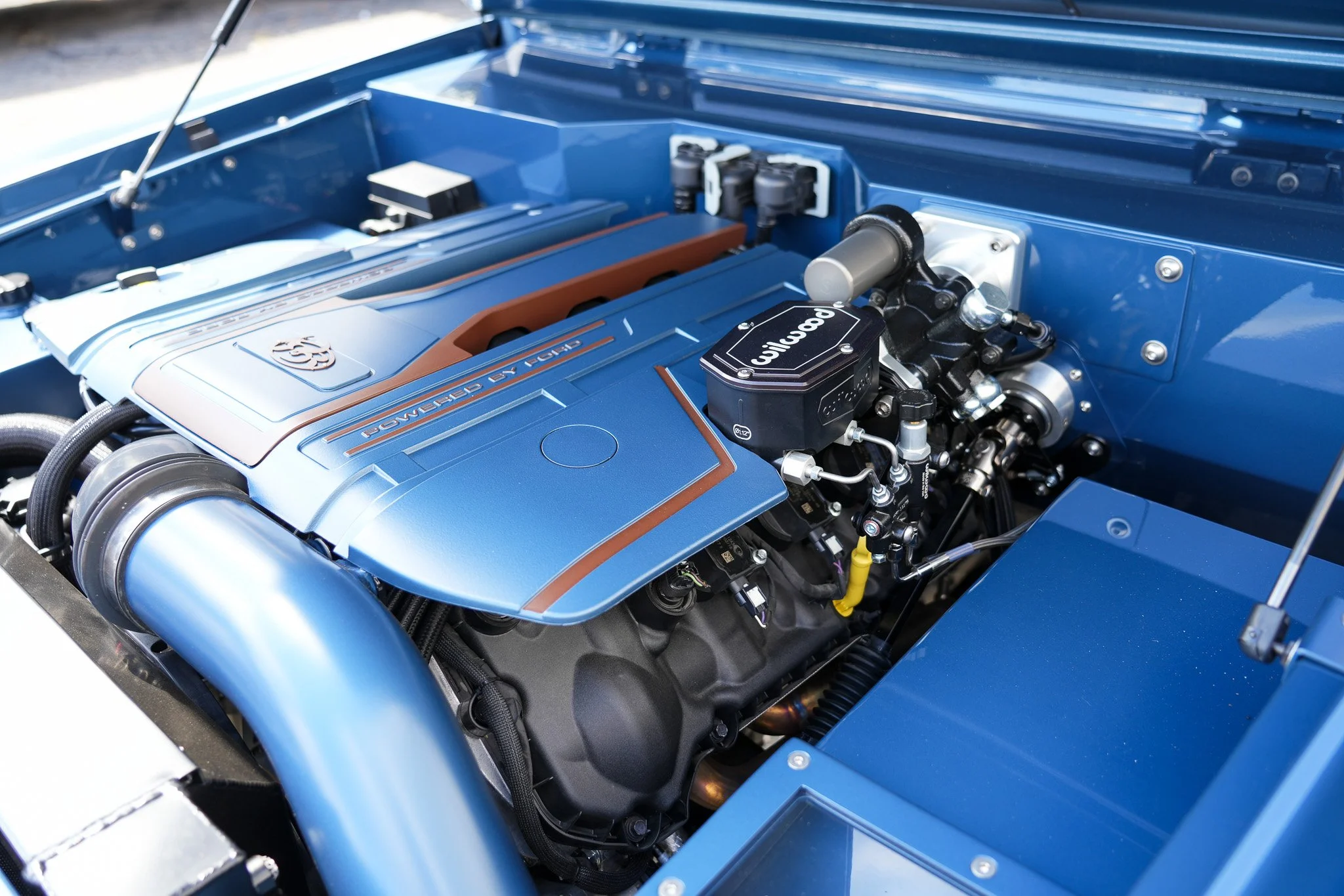 Close-up of a highly detailed blue car engine with branded components.