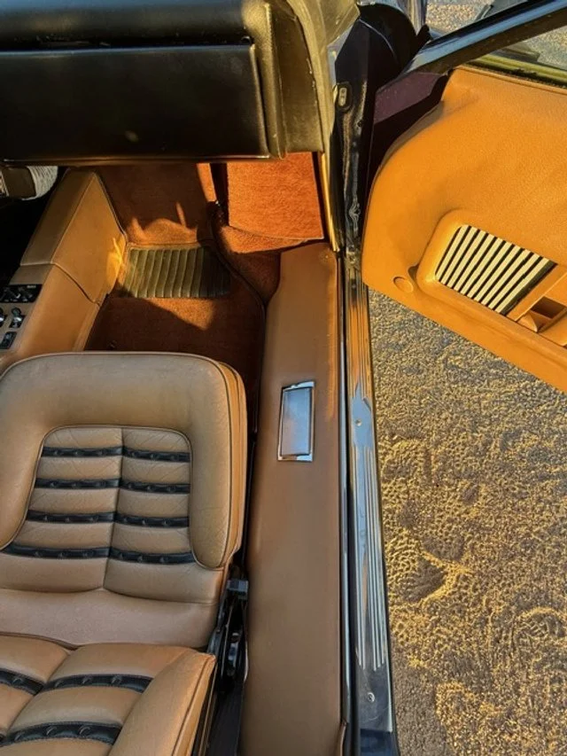Tan and black passenger seat of Blue 1979 Ferrari 512 BB 